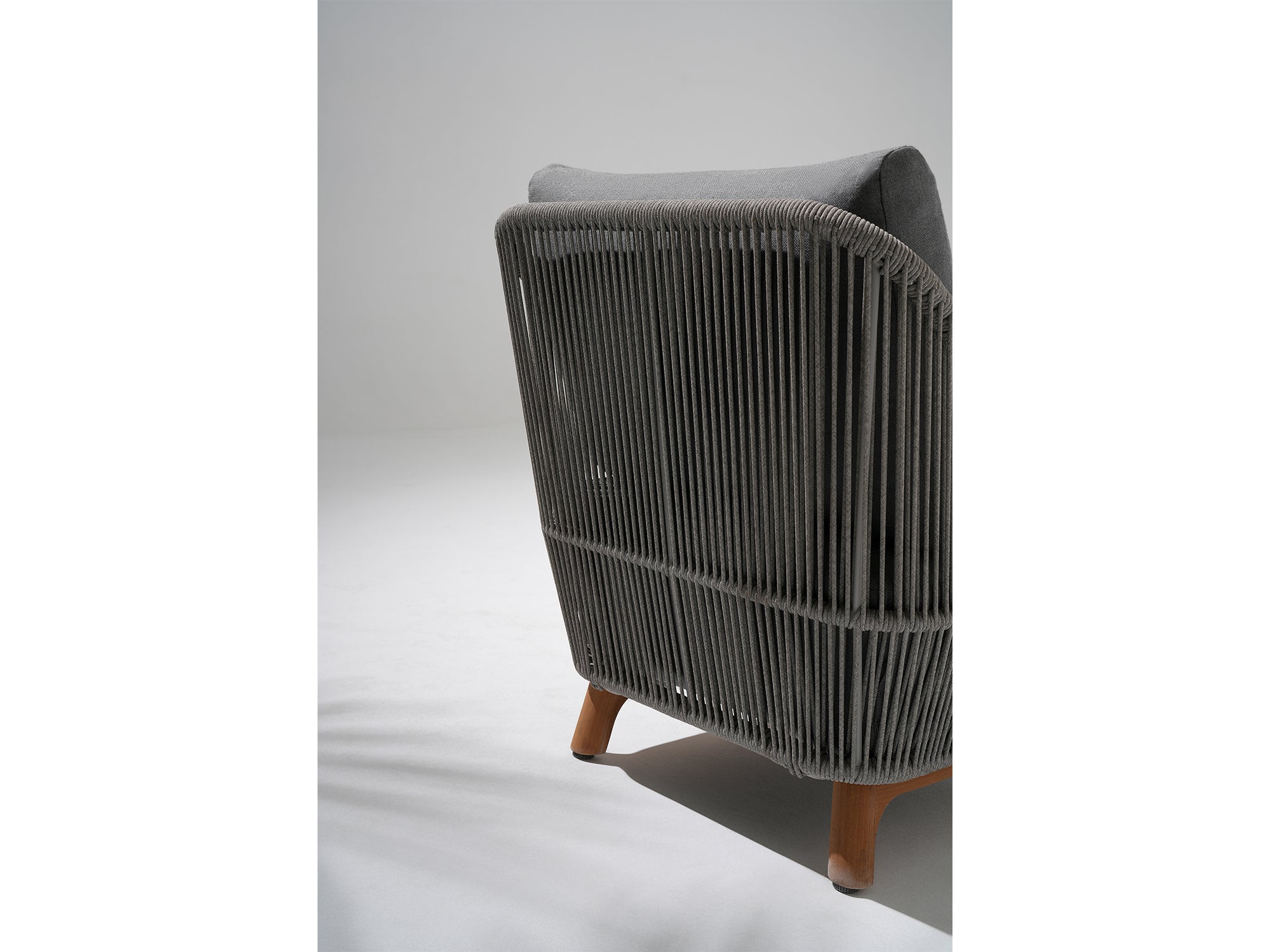 Modern chair with woven design, teak legs