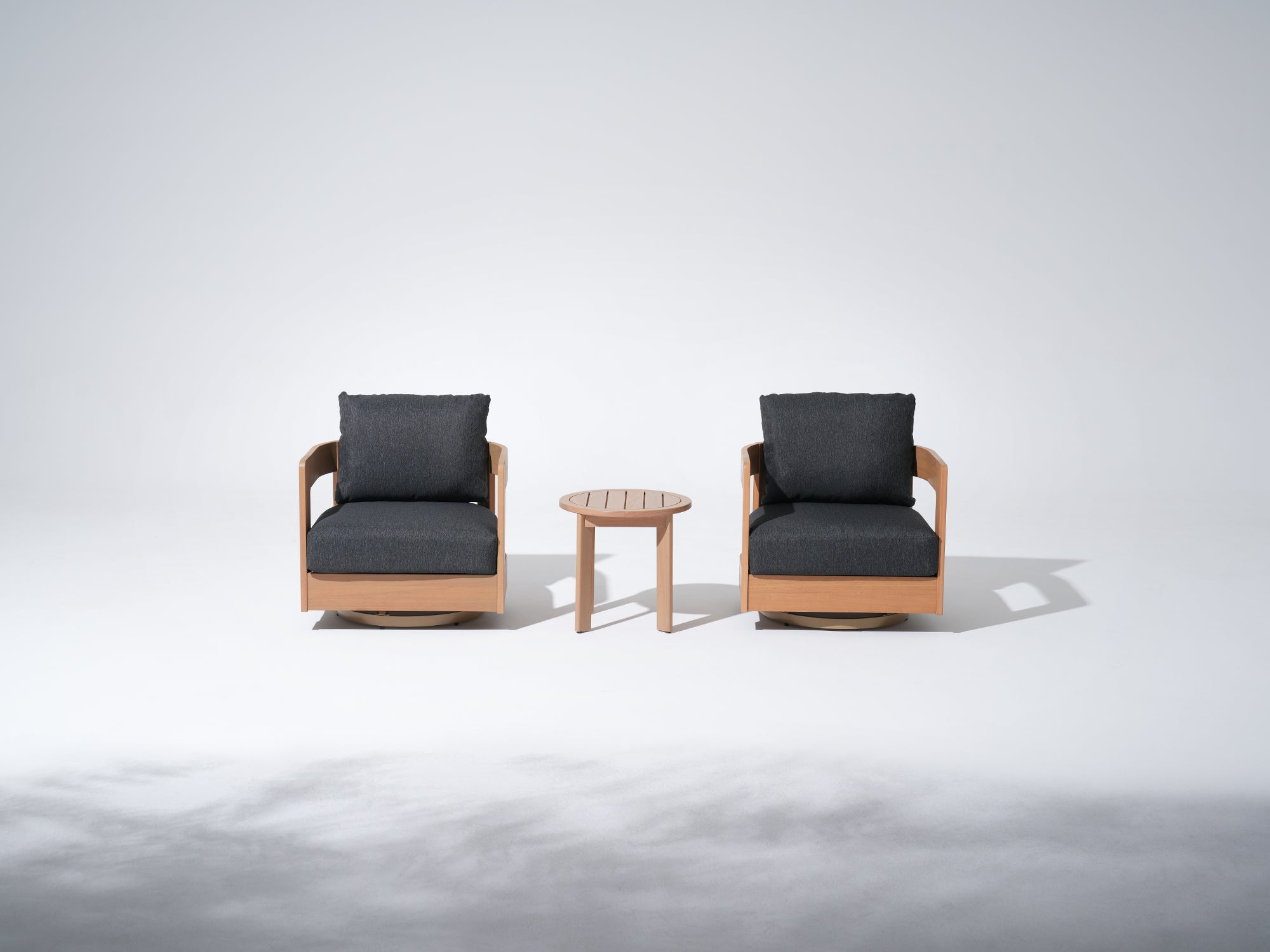 Two Eucalyptus wooden swivel armchairs with dark cushions and a small round table - Jardina Modern Premium Outdoor Patio Furniture Set