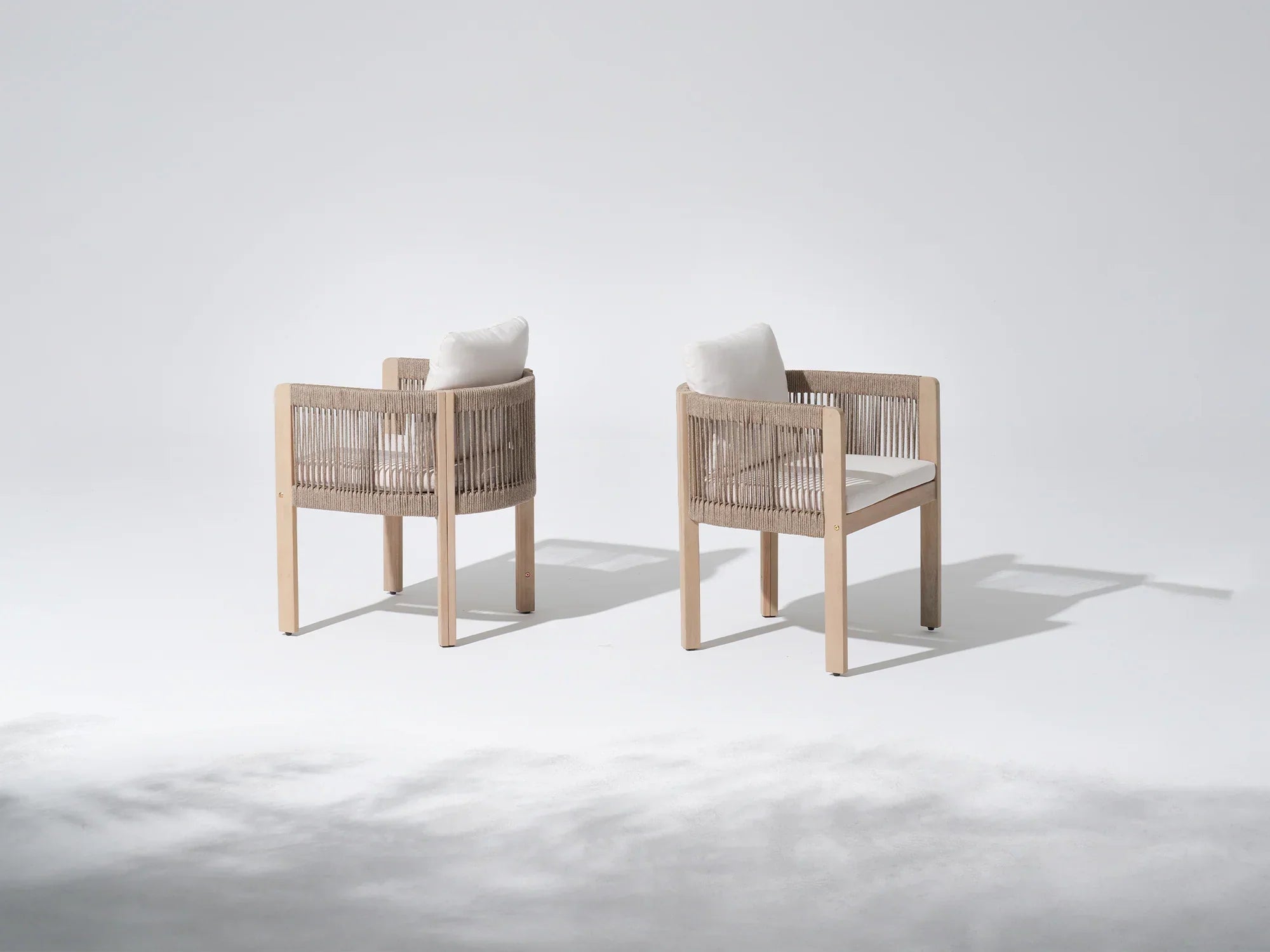 Two acacia wooden dining chairs with woven backrests and white cushions - Jardina Premium Modern Outdoor Dining Furniture