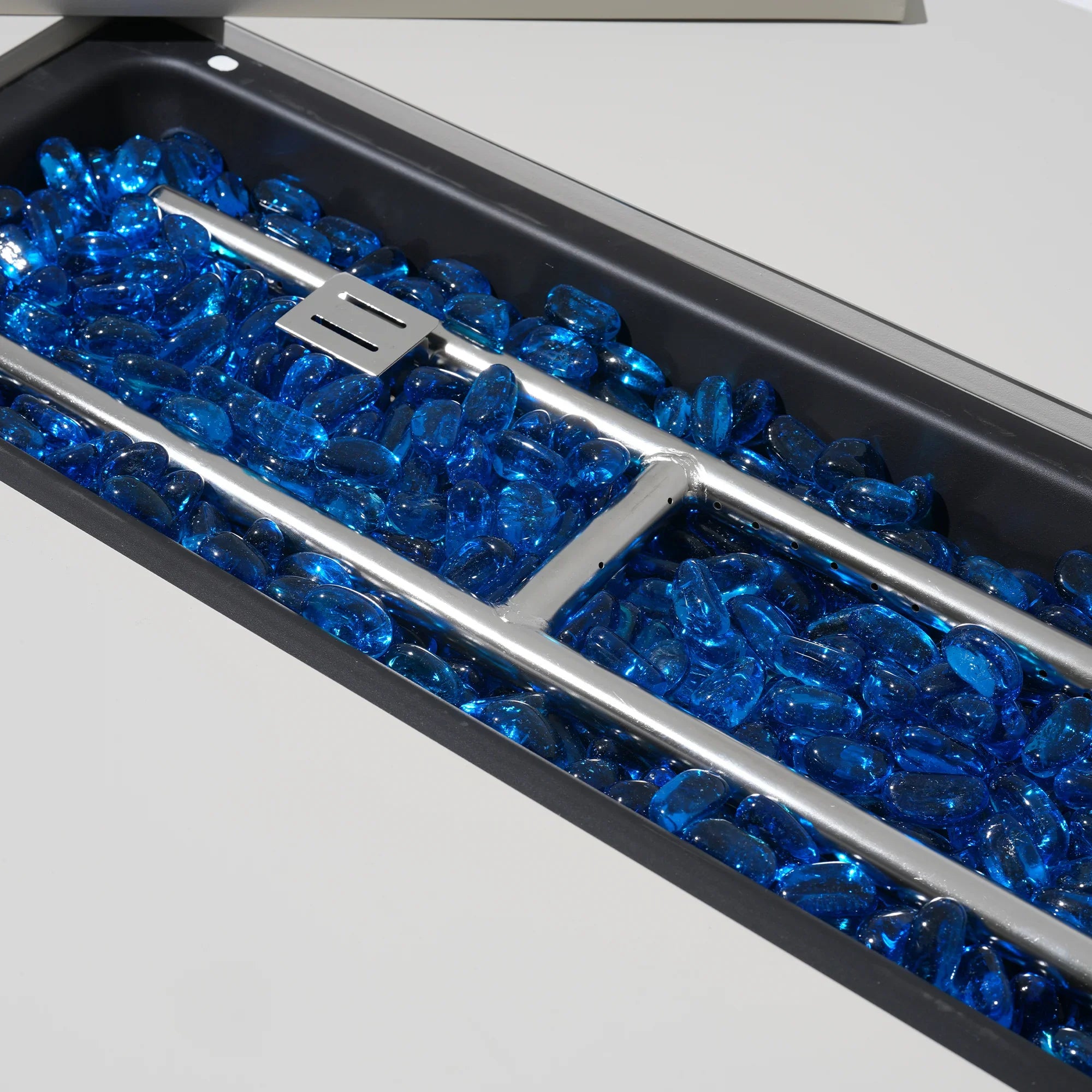 Close-up of a fire pit with blue glass stones