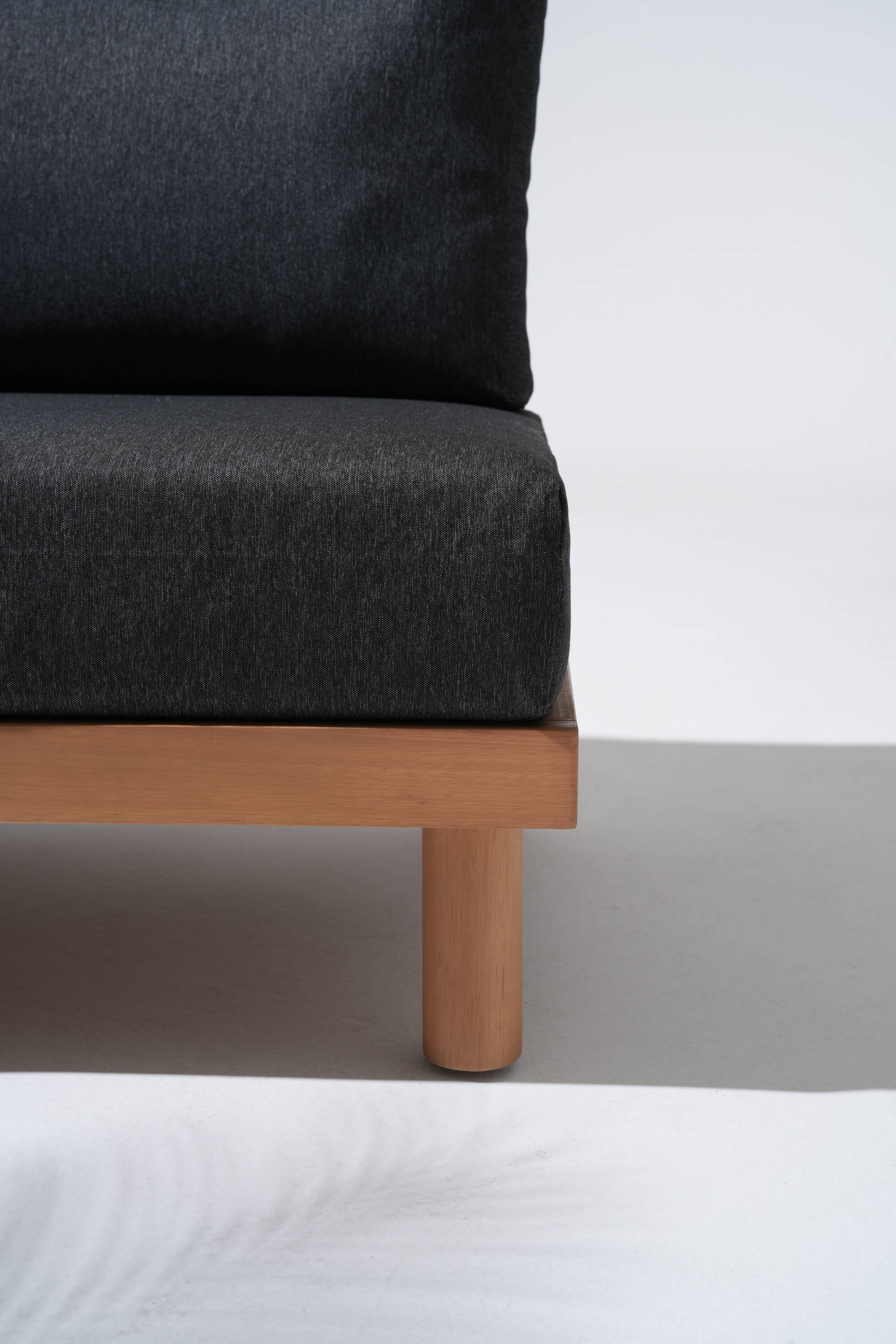 Dark gray upholstered chair with wooden legs