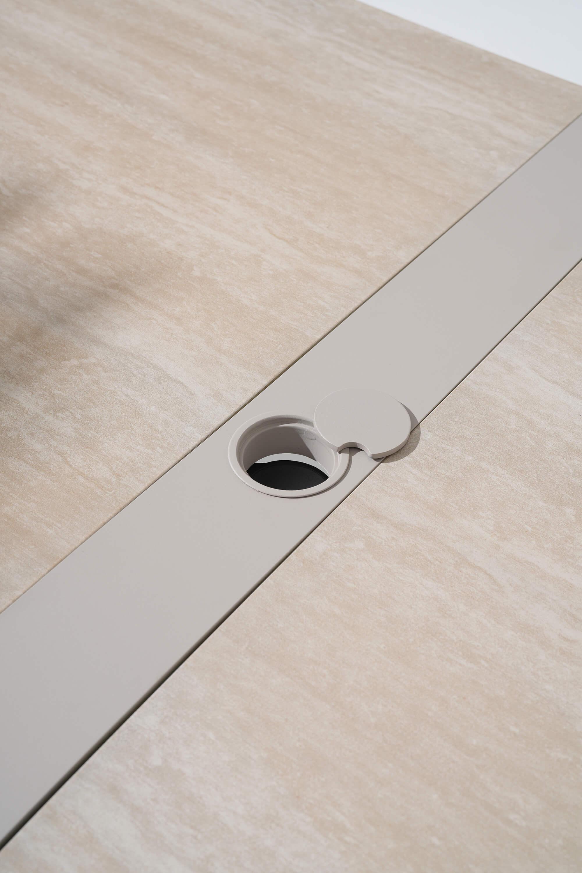 Close-up of a wooden surface with a metallic strip and circular hole