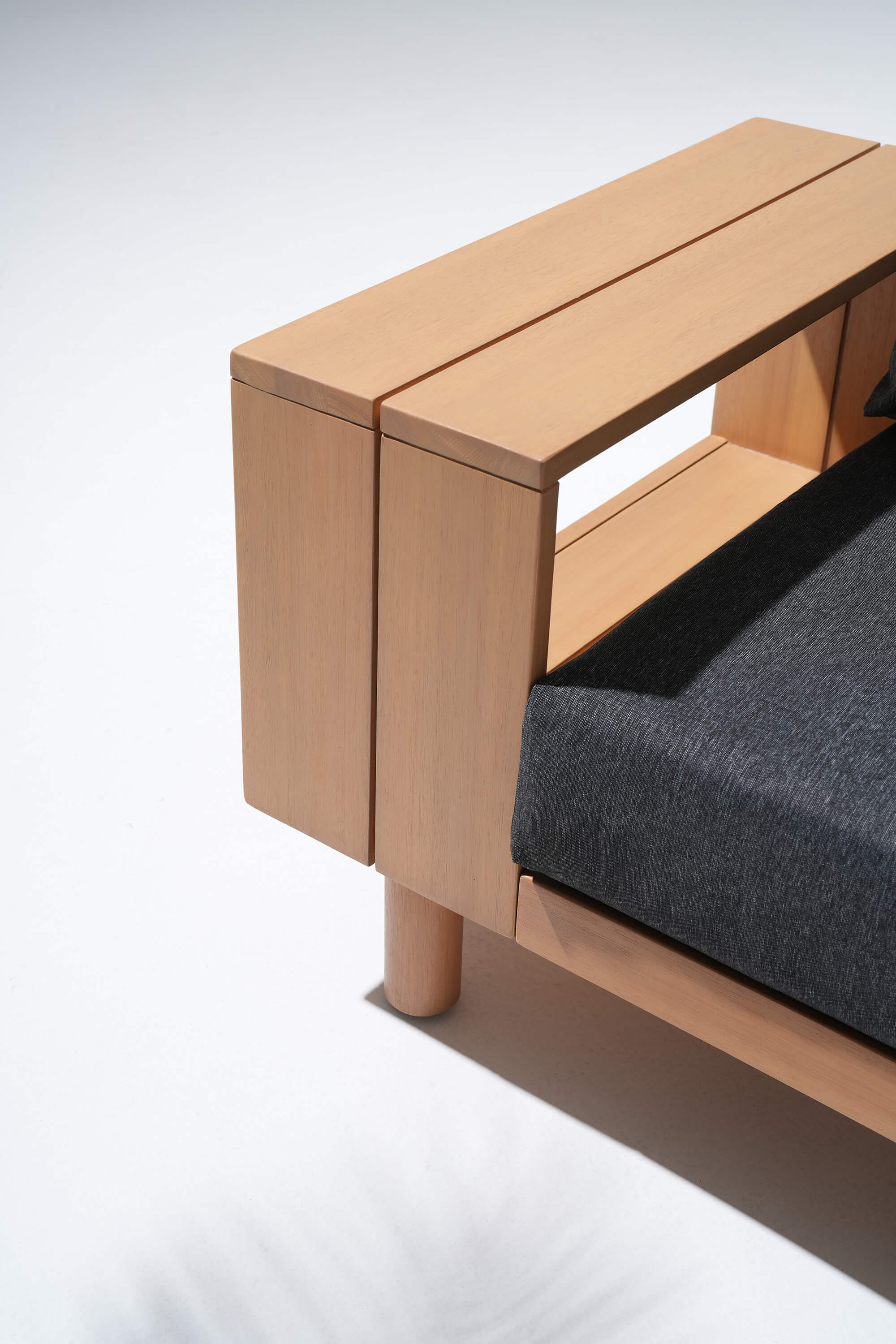 Wooden bench with a dark cushion