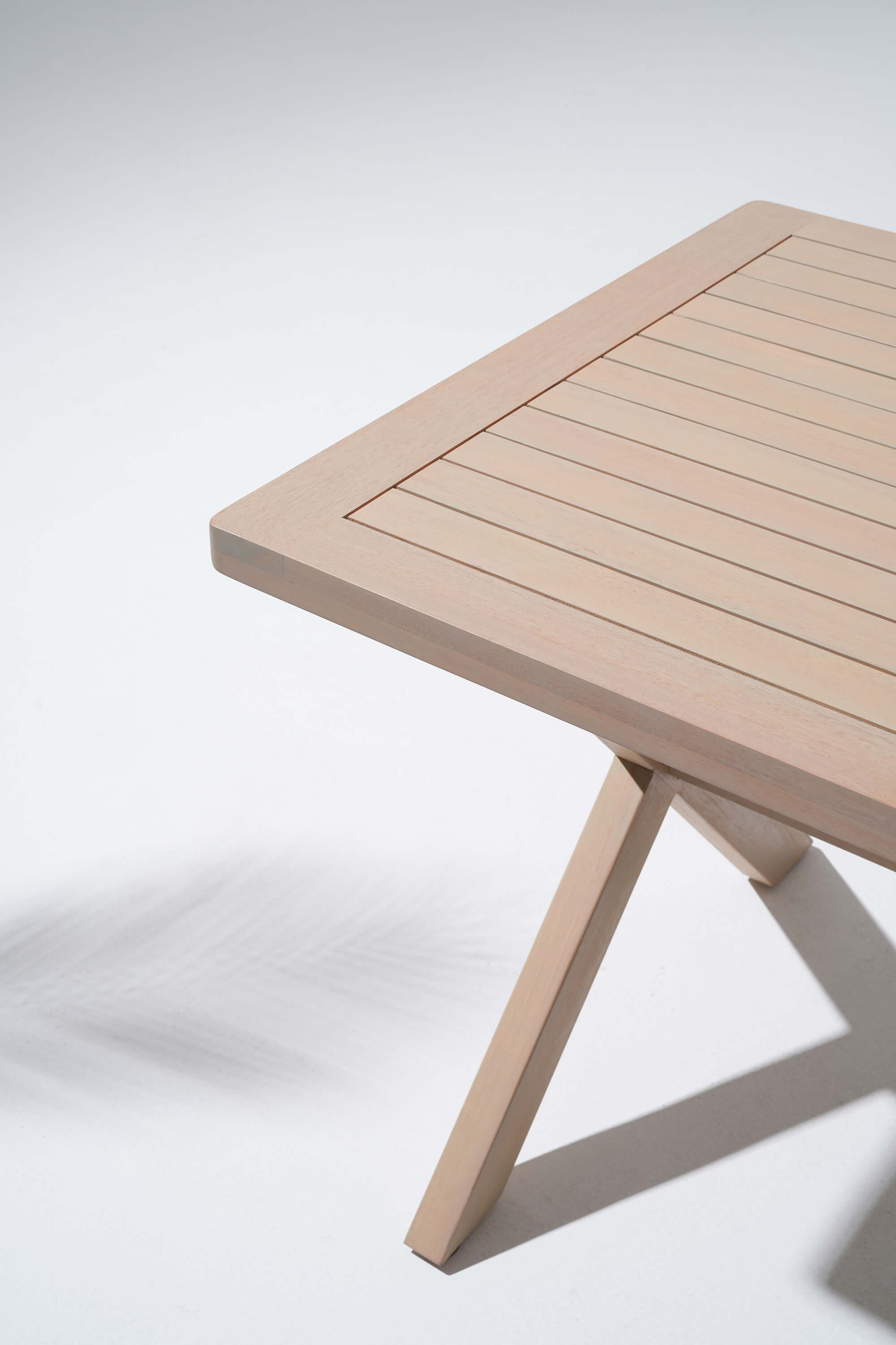 Wooden table with slatted design on a white background