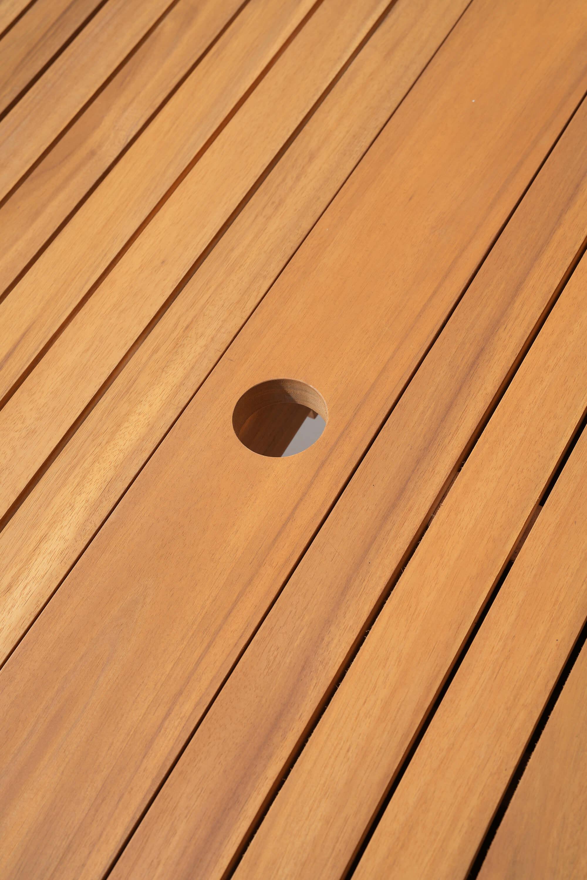 Close-up of a wooden deck with a circular hole