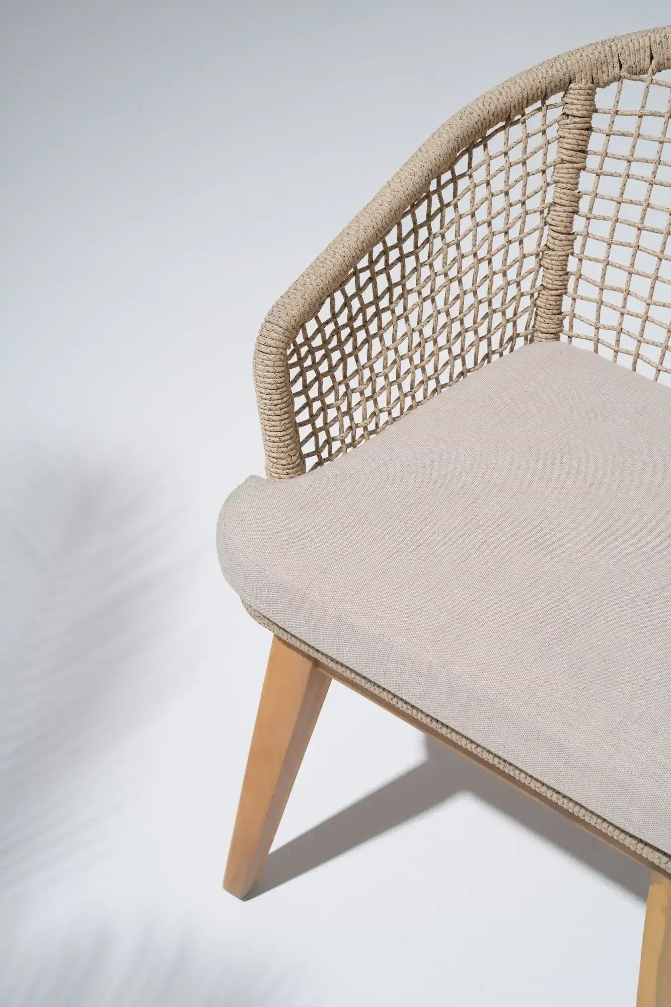 Chair with woven backrest and beige cushion