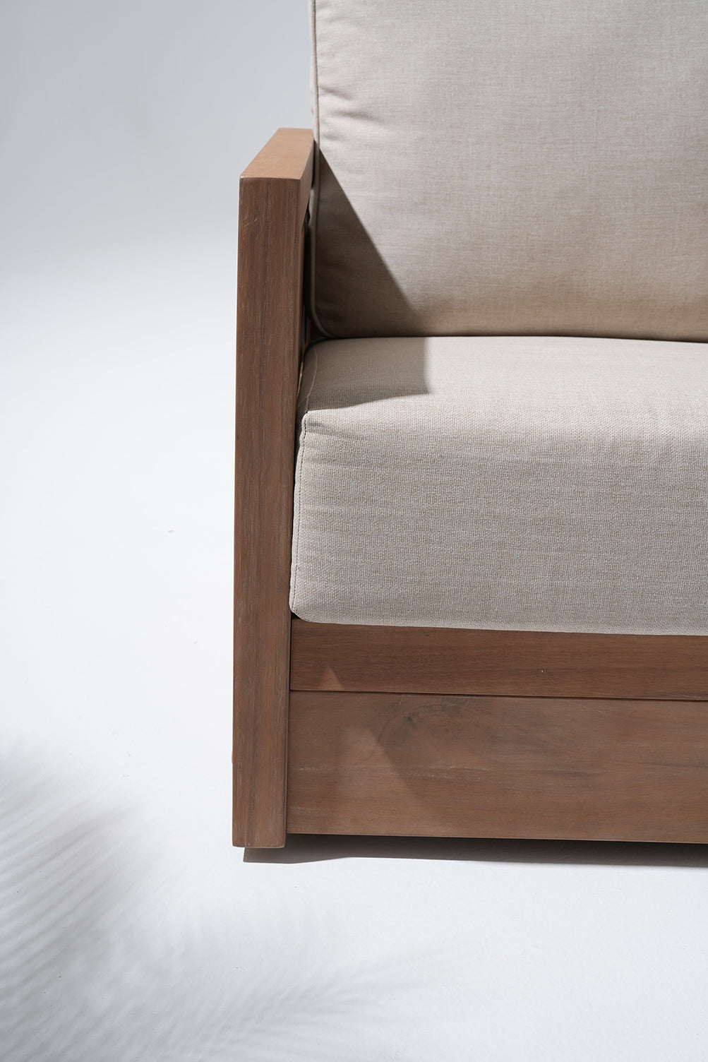 Close-up of a acacia wooden chair with beige cushion