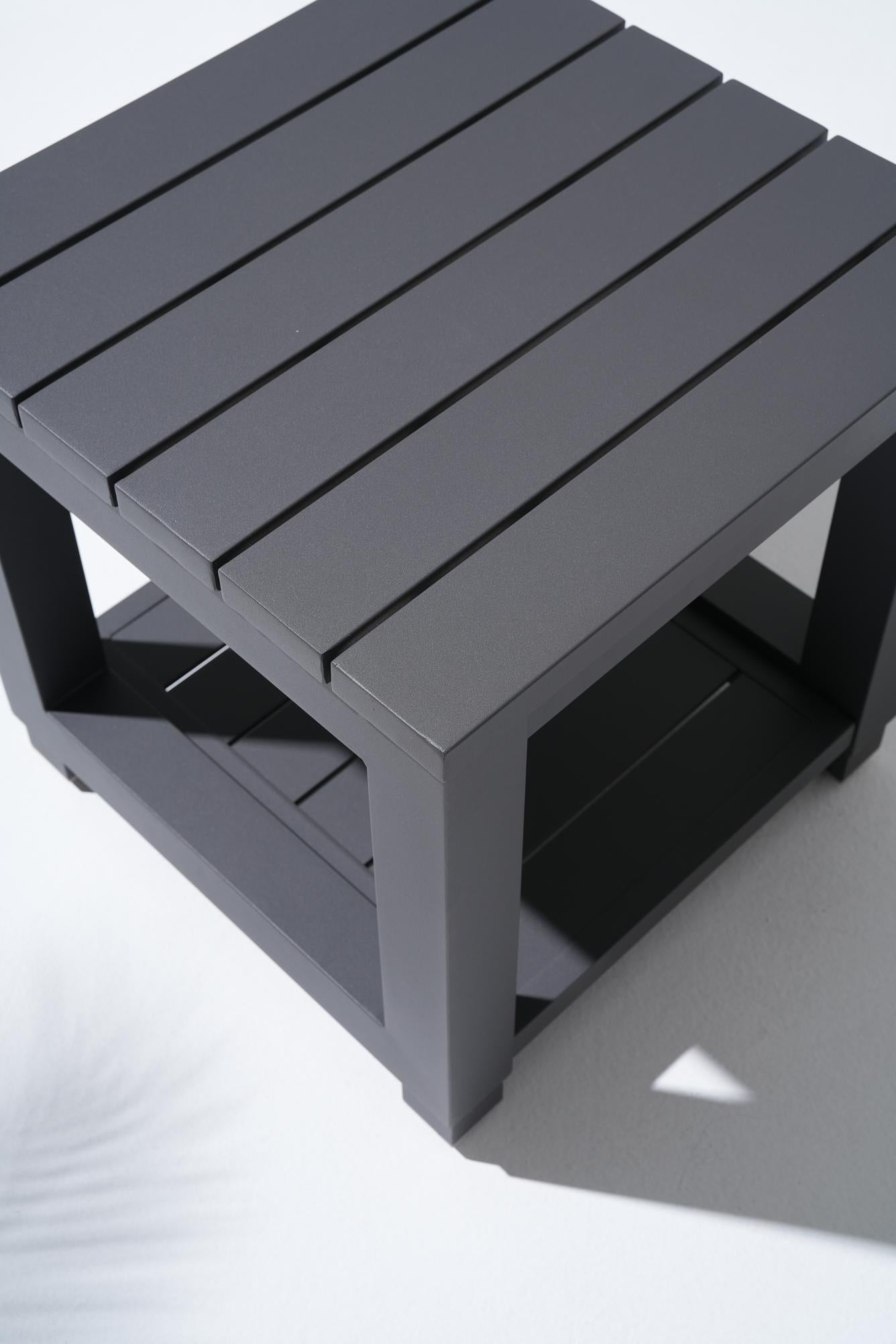 Gray aluminum side table with slatted design tabletop