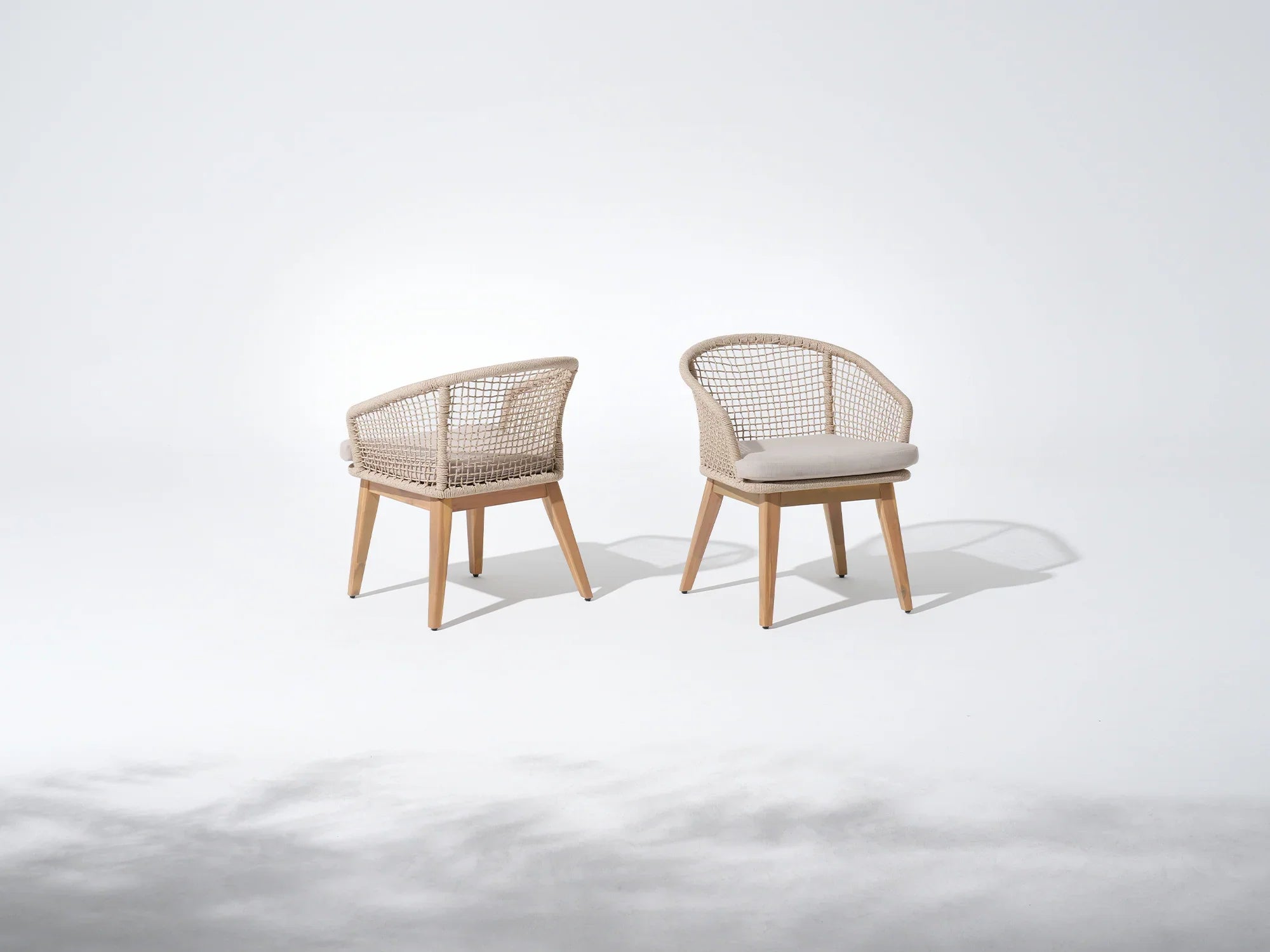 Two acacia wooden chairs with woven backrests and cushioned seats- Jardina Premium Modern Outdoor Dining Furniture