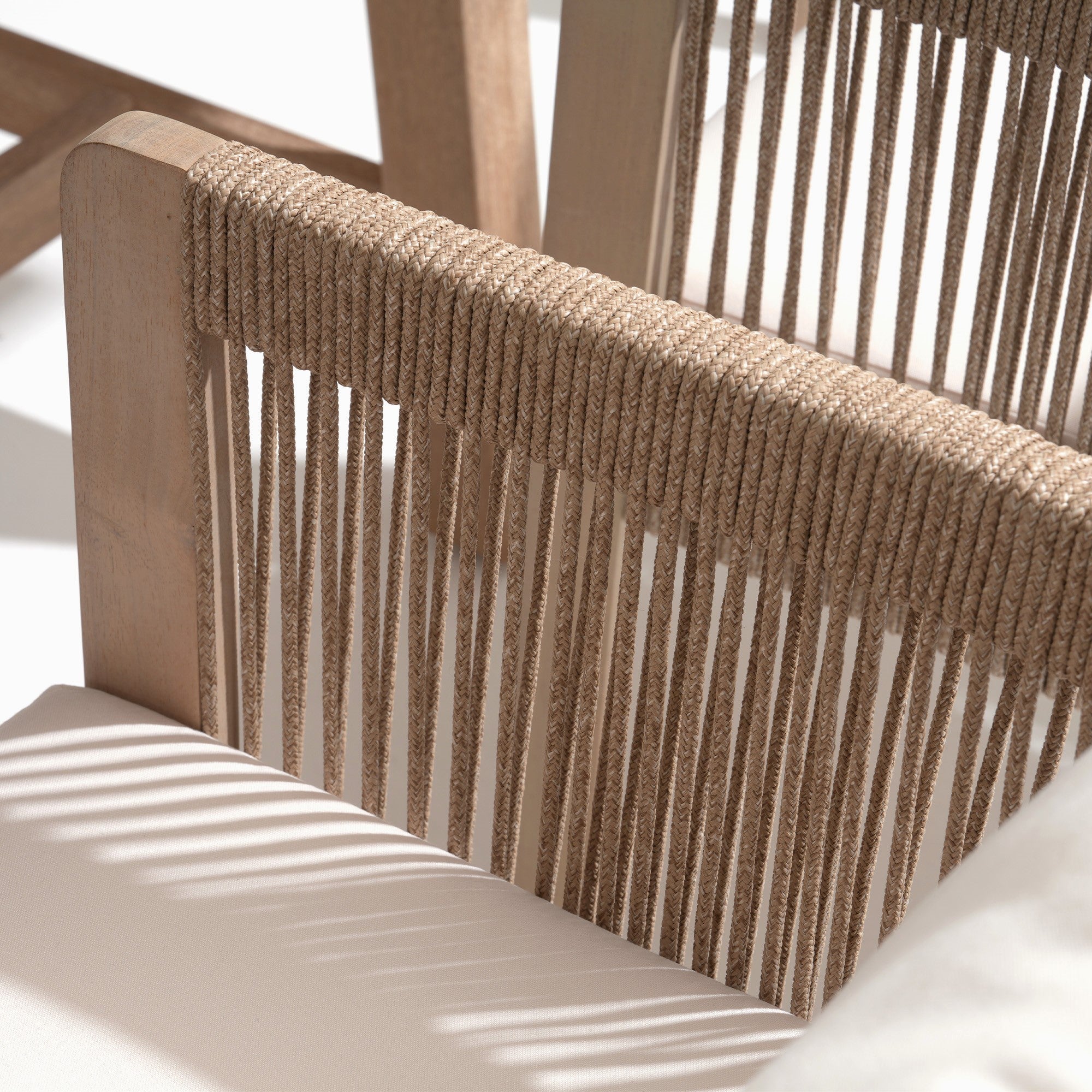 Close-up of a woven rope chair back with natural wood framerectnagular wood patio dining tabletop detail - Jardina Modern Premium Outdoor Patio Furniture