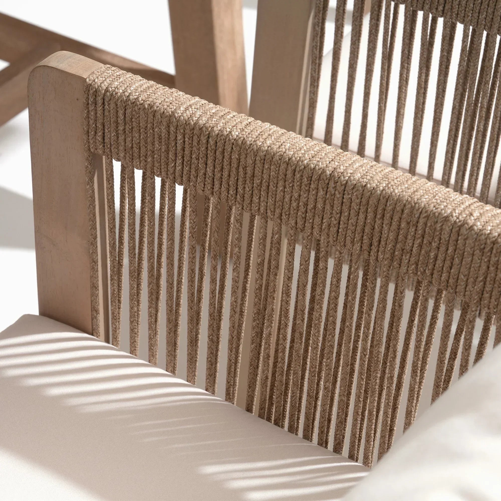 Close-up of a woven rope chair back with natural wood framerectnagular wood patio dining tabletop detail - Jardina Modern Premium Outdoor Patio Furniture