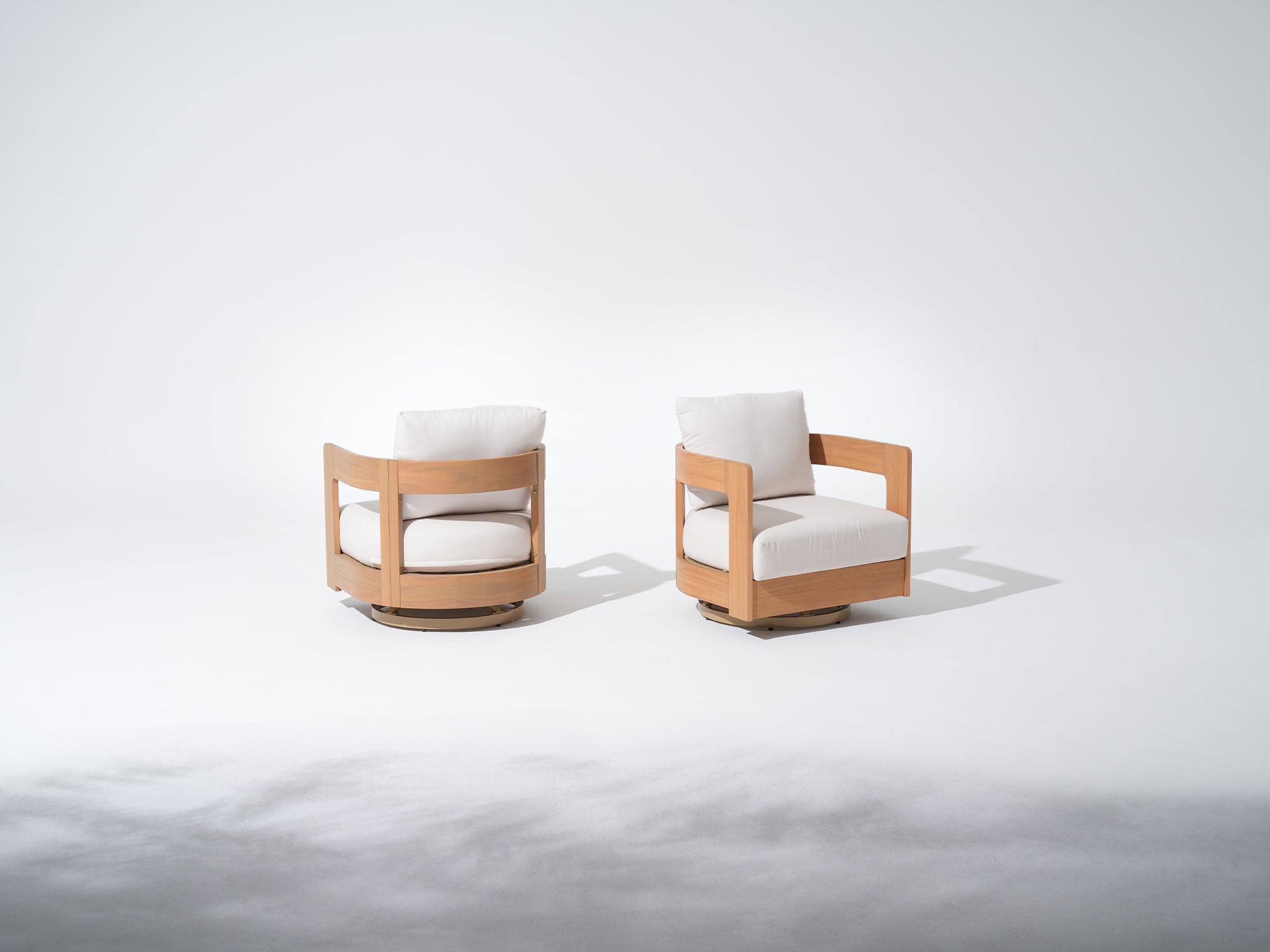 Two modern swivel chairs with Eucalyptus wooden frames and white cushions#Color_White