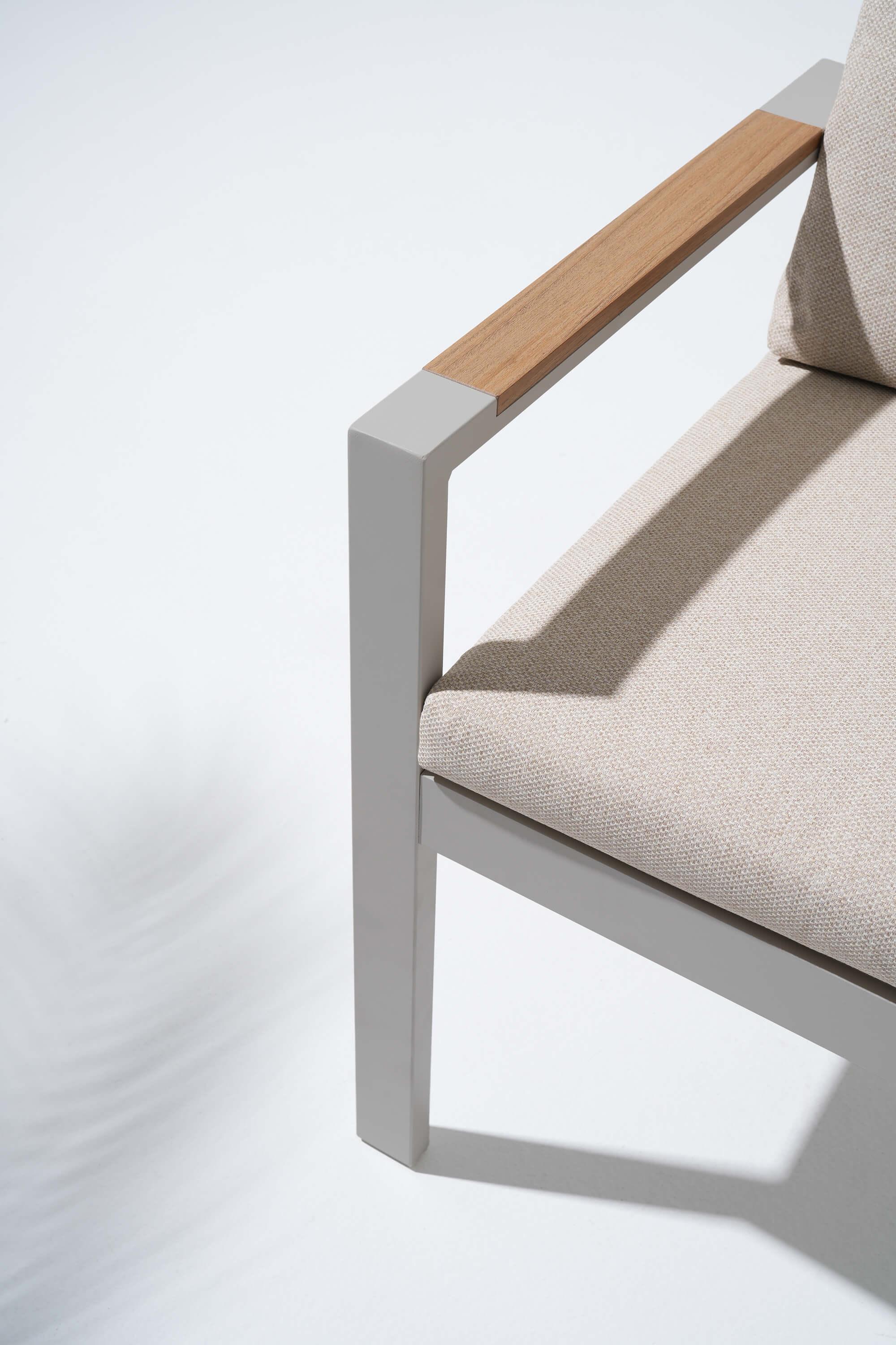 Chair with beige cushion and wooden armrest