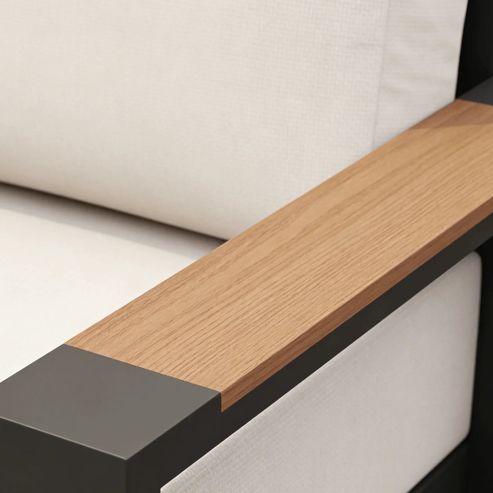 Close-up of a modern sofa with wooden armrest and black base.