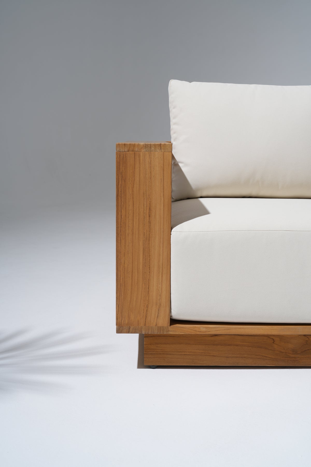 close-up of Braga teak wood outdoor couch with white thick seat cushion- Jardina