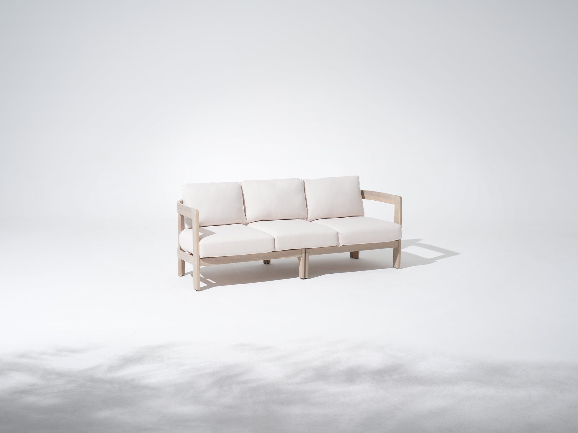 Minimalist natural acacia wood outdoor couch with curved armrest and white cushions - Jardina Modern Premium Outdoor Patio Furniture