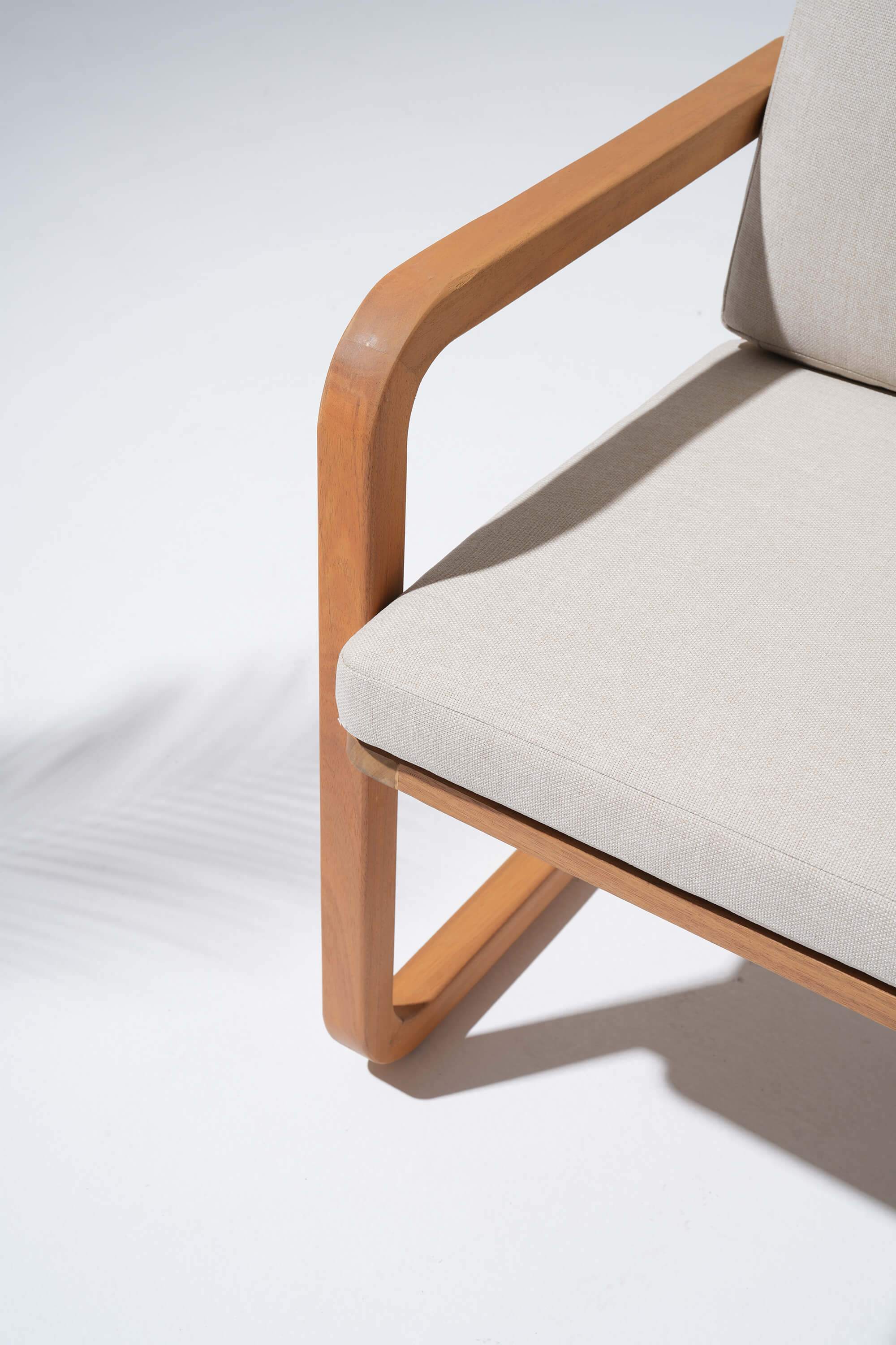 Chair with wooden frame and beige cushion