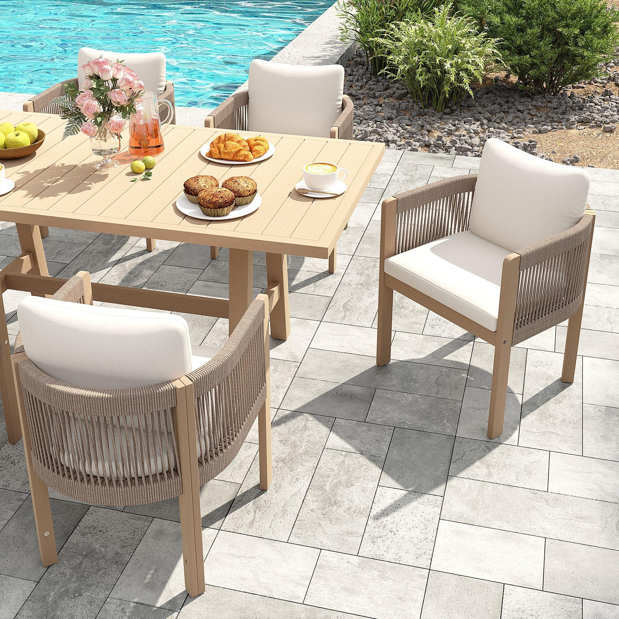 Outdoor patio dining set with table and chairs by a poolside, acacia wooden and hand woven rope design, white cushions - Jardina Modern Premium Outdoor Patio Furniture Sets