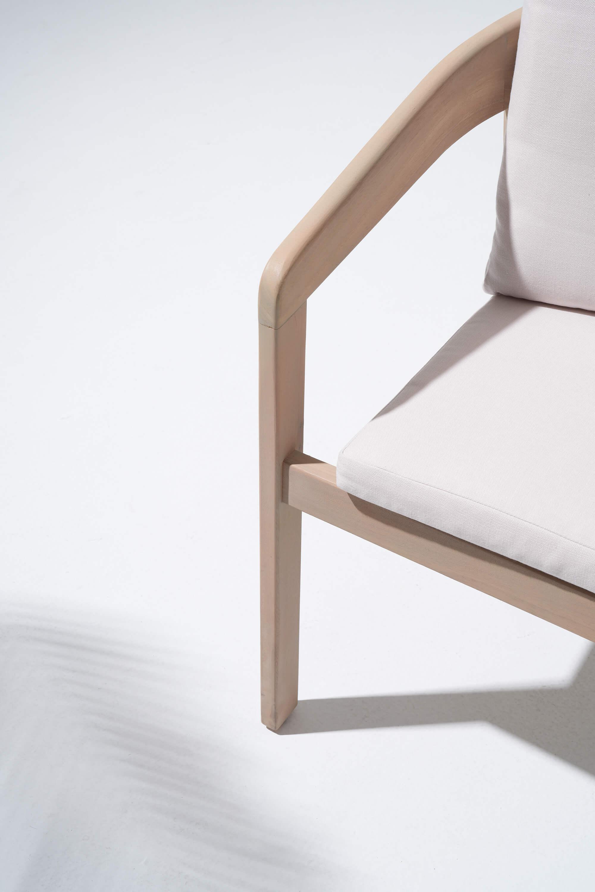 Chair with light wooden frame and white cushion