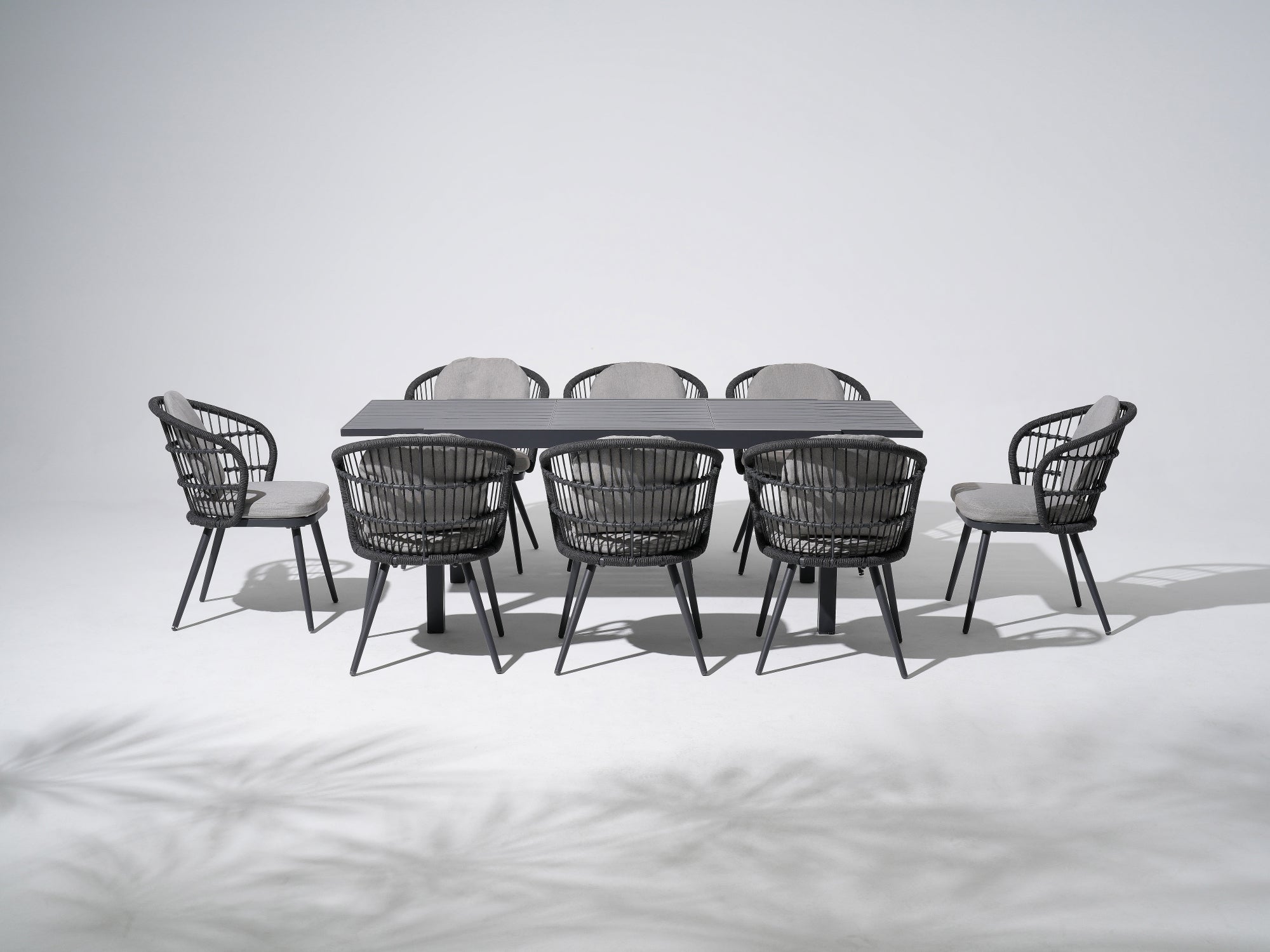 Aluminum 8-person Outdoor Dining Set, 8 dining chairs with grey cushions, woven rope design, and a 59'' to 83'' Extendable Dining Table - Jardina Outdoor Dining Furniture
