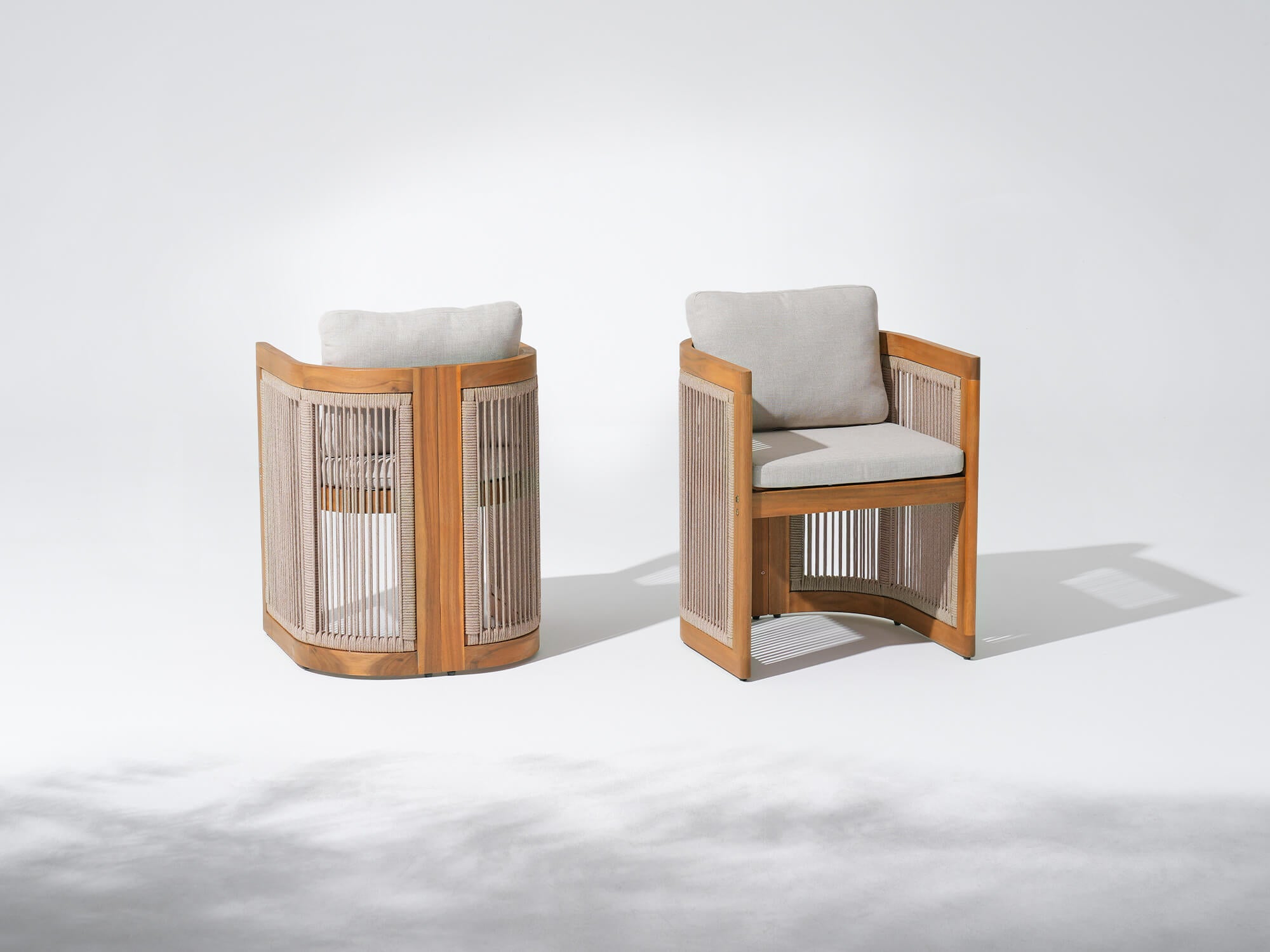 Two acacia wooden patio dining chairs with woven rope backrests and grey cushions- Jardina Modern Premium Patio Outdoor Furniture