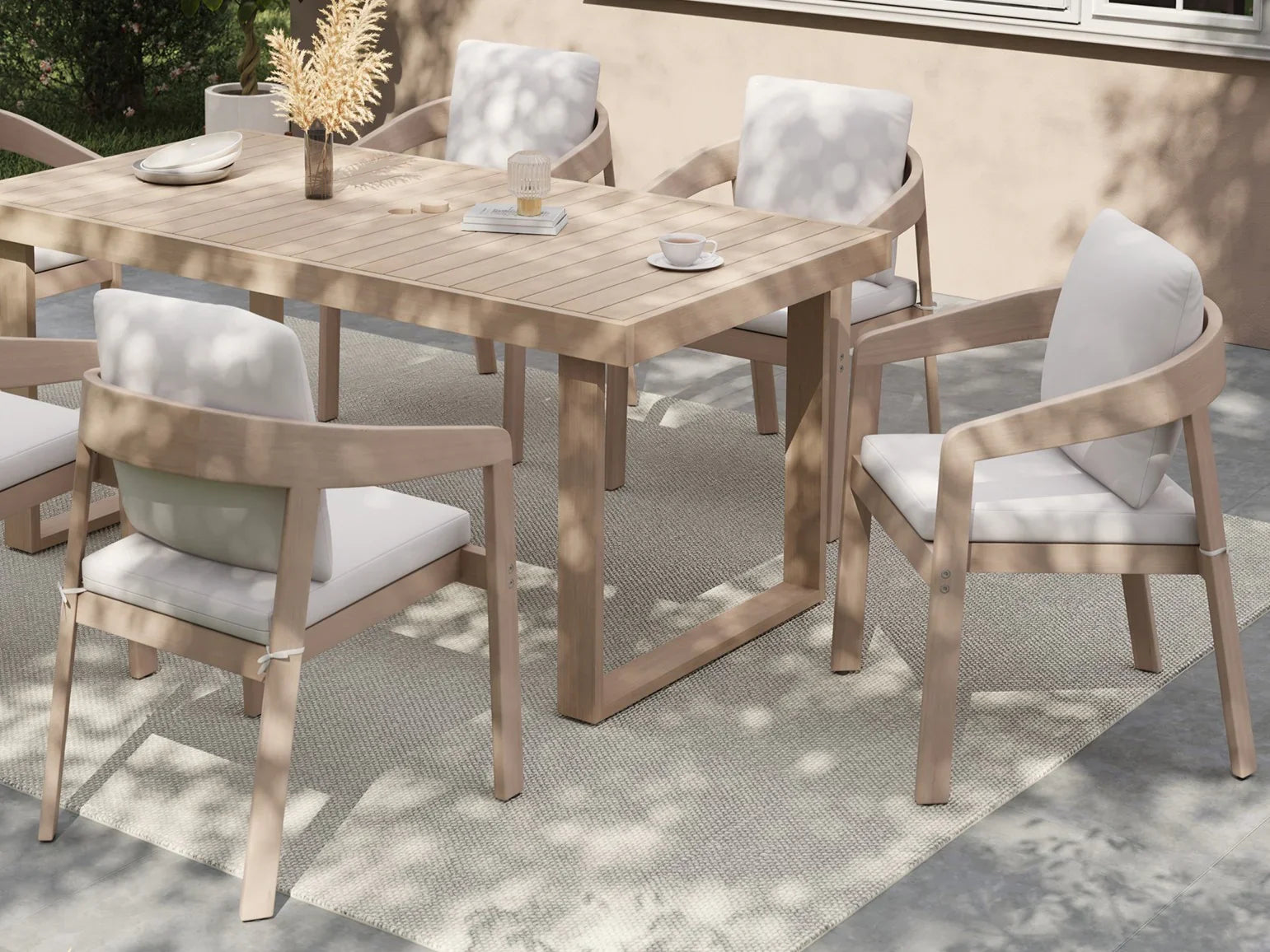 Eucalyptus Wooden outdoor dining table with chairs and cushions on a patio - Jardina Premium Modern Outdoor Dining Furniture