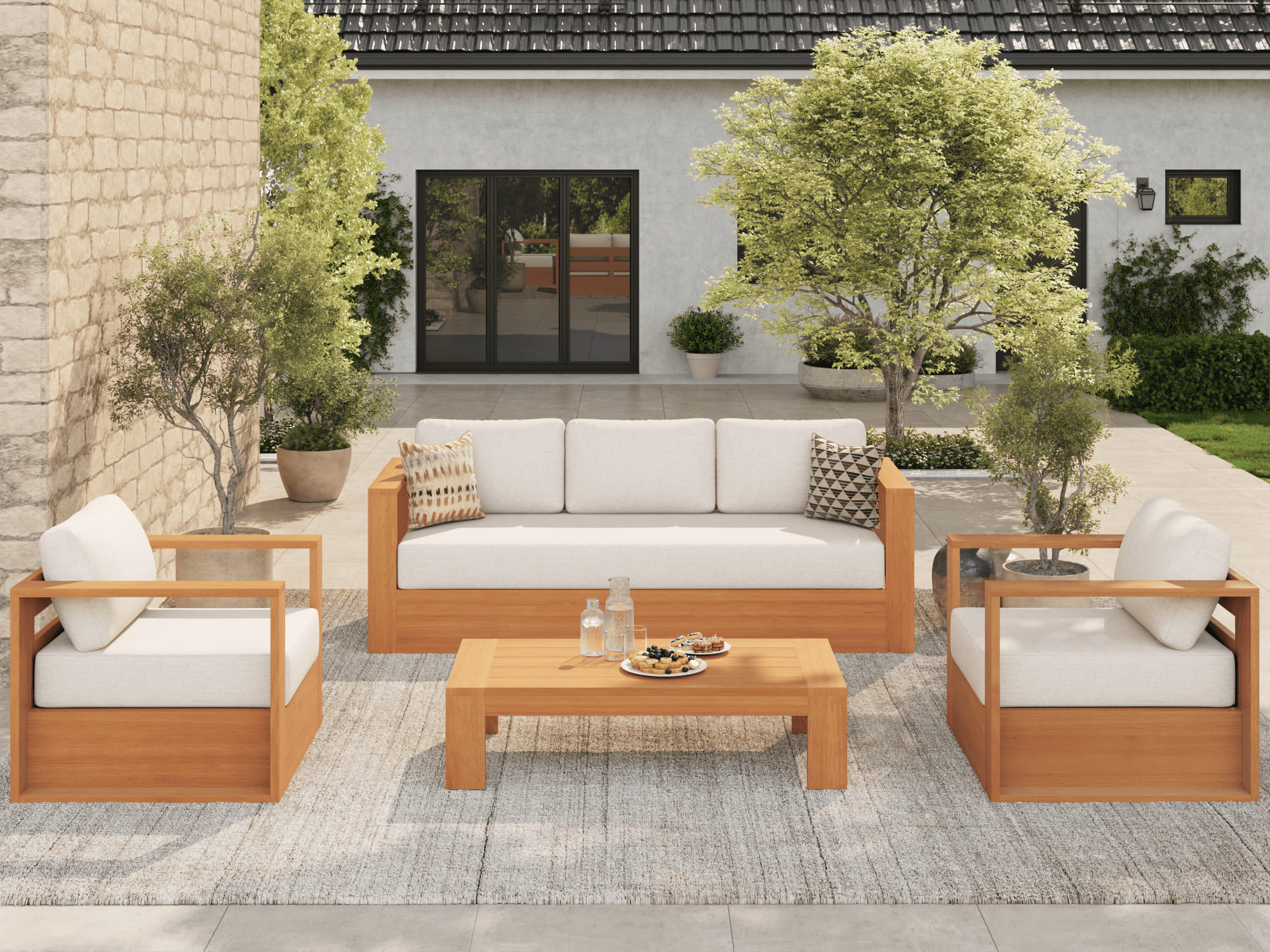 Outdoor patio furniture set with wooden frames and white cushions on a patio- Jardina outdoor conversation seating set