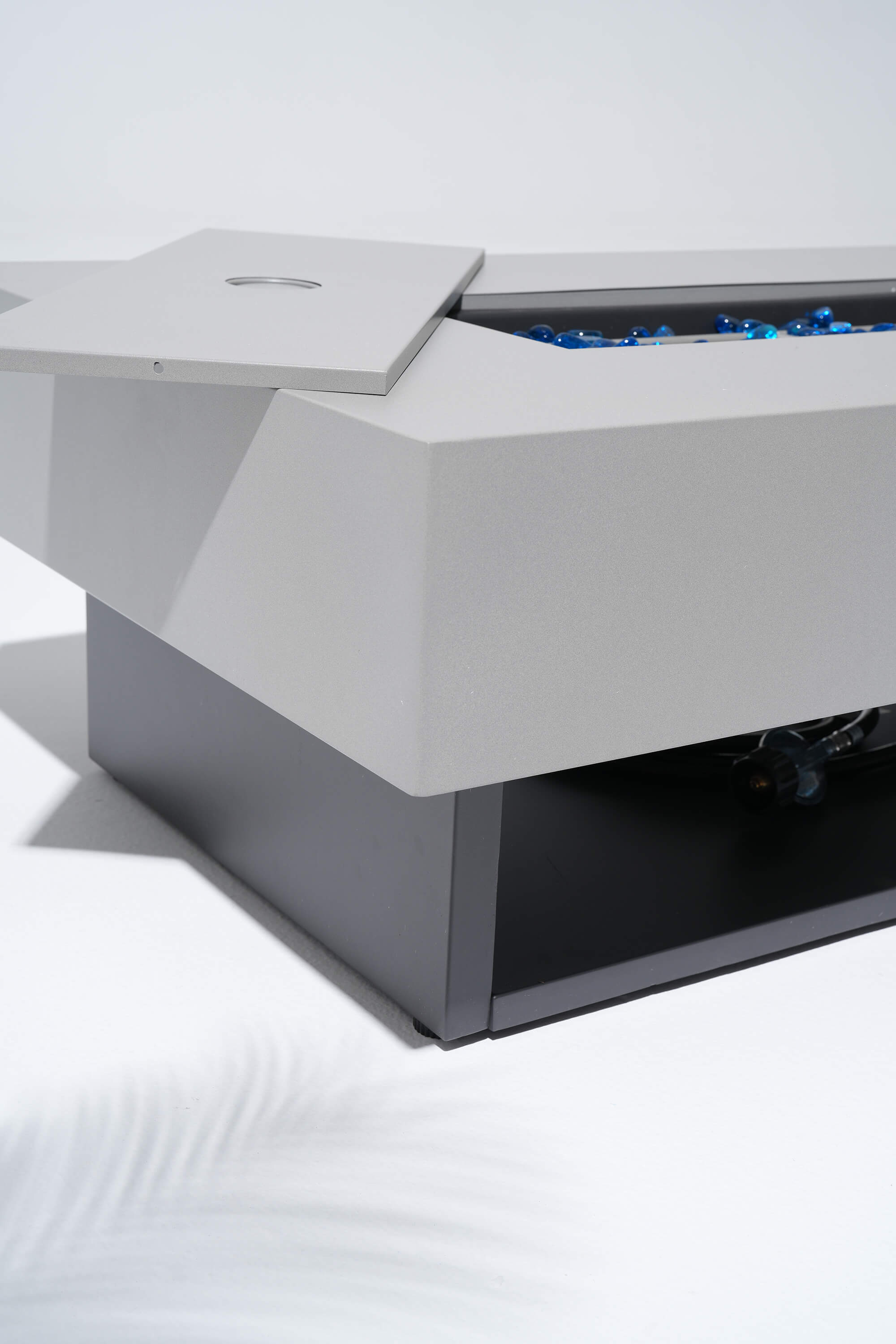 Modern outdoor fire pit table with blue flames on a white background #color_grey