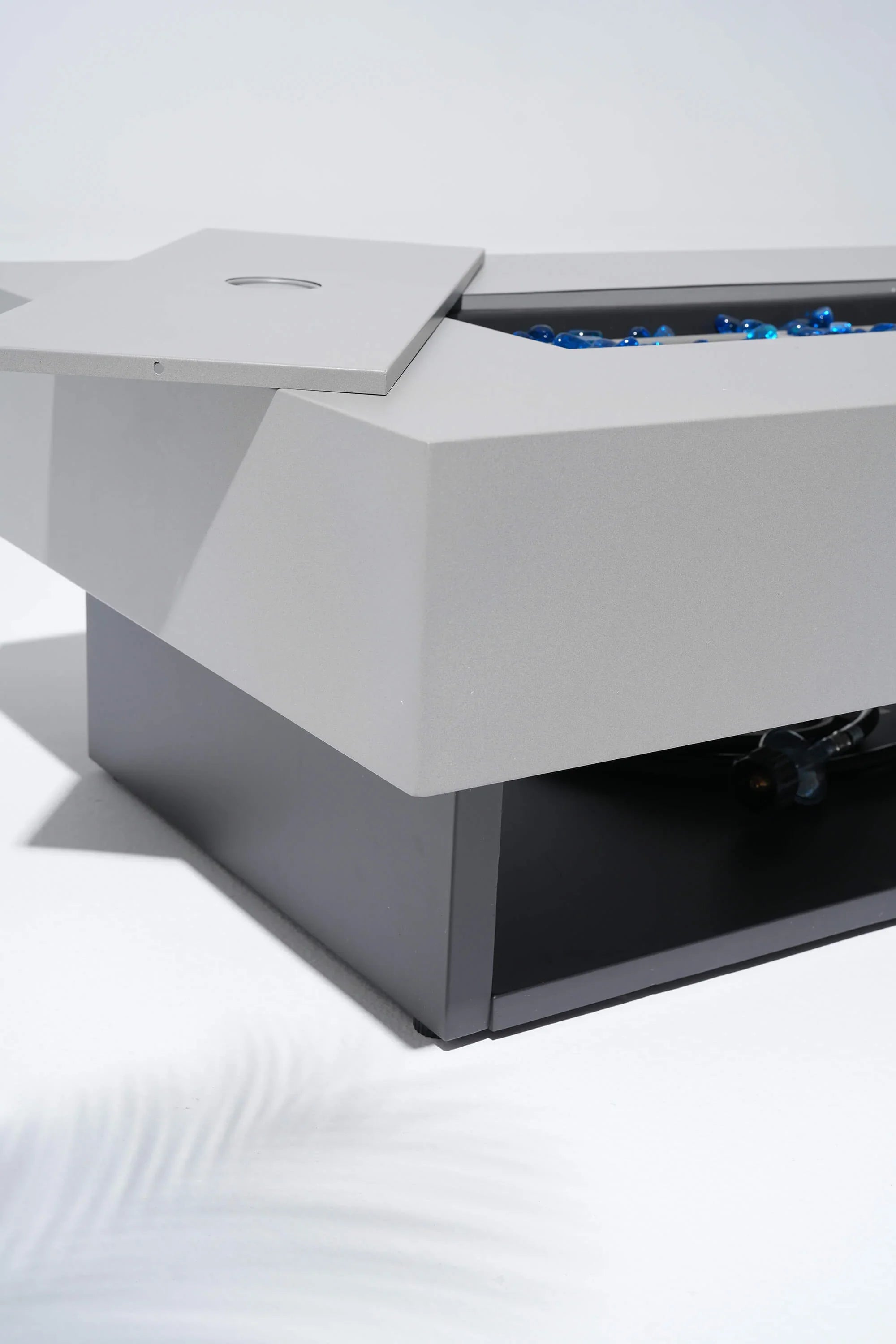 Modern outdoor fire pit table with blue flames on a white background #color_grey