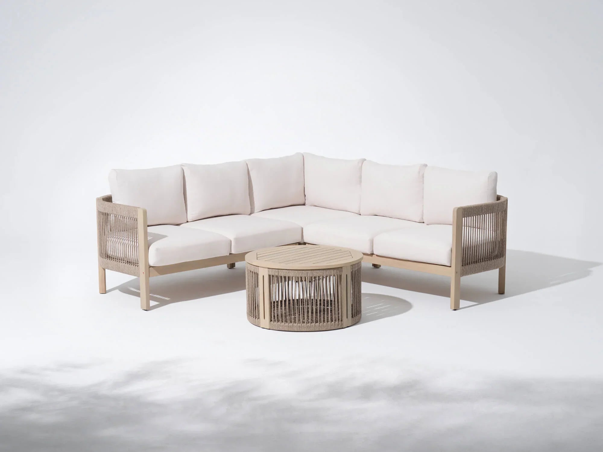 Foristern L-shaped outdoor sectional sofa with white cushions and a matching coffee table, acacia wooden frame and rope design - Jardina Modern Premium Outdoor Patio Furniture Sets