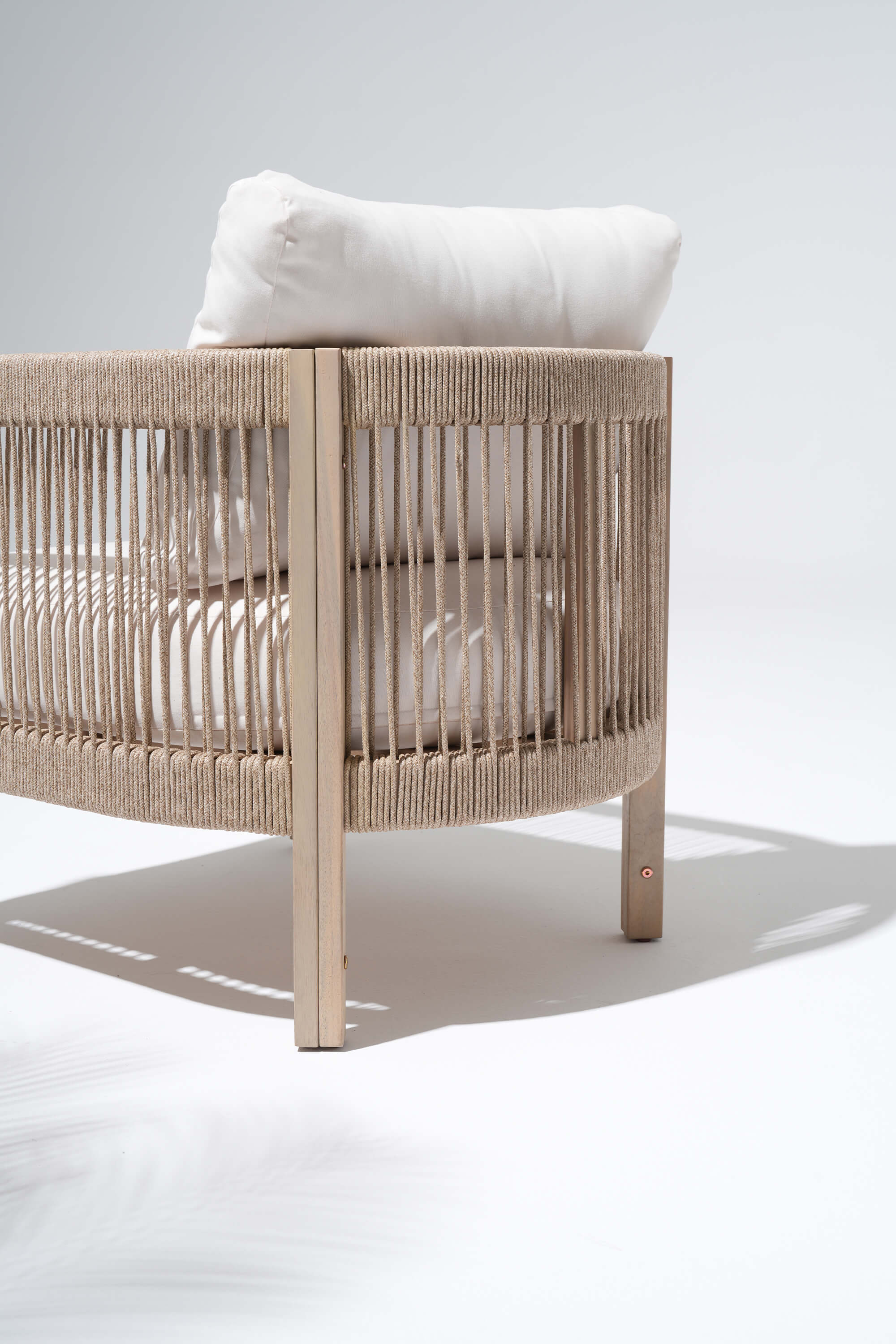 Beige crib with a white pillow, woven rope backrest detail - Jardina’s Modern Premium Outdoor Furniture