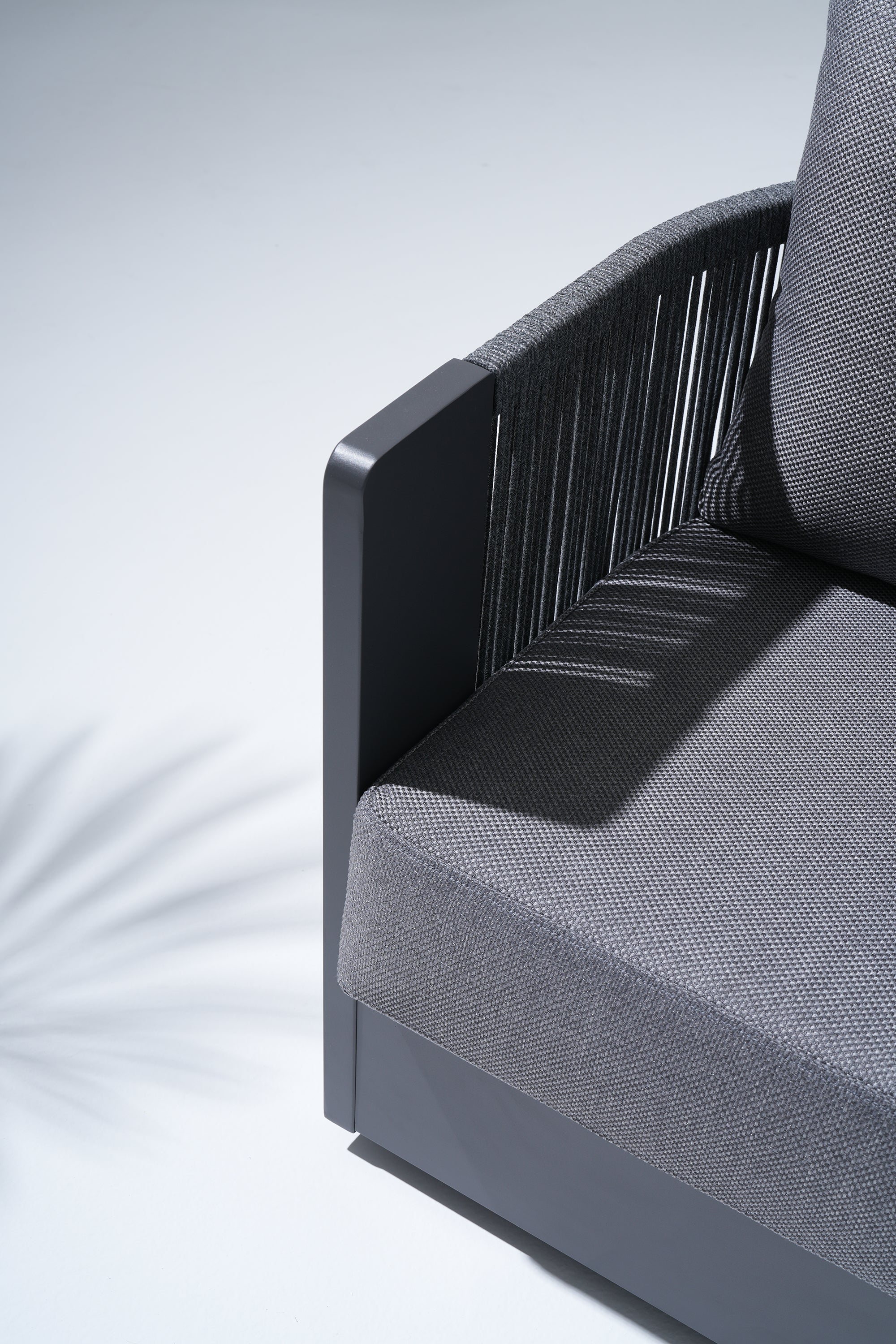 Gray outdoor sofa with aluminum frame and rope armrest