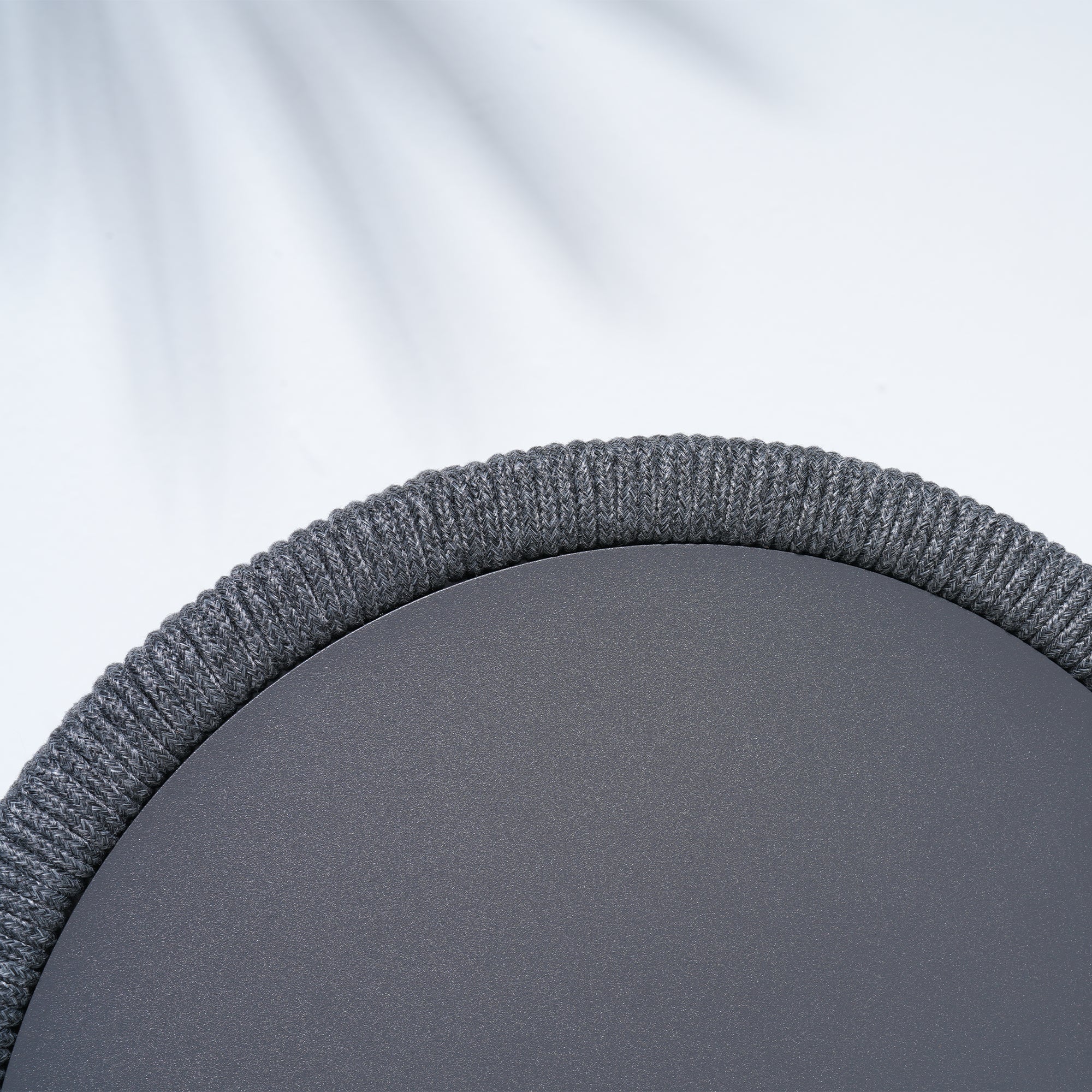 Close-up of a gray coffee table with rope design and aluminum frame