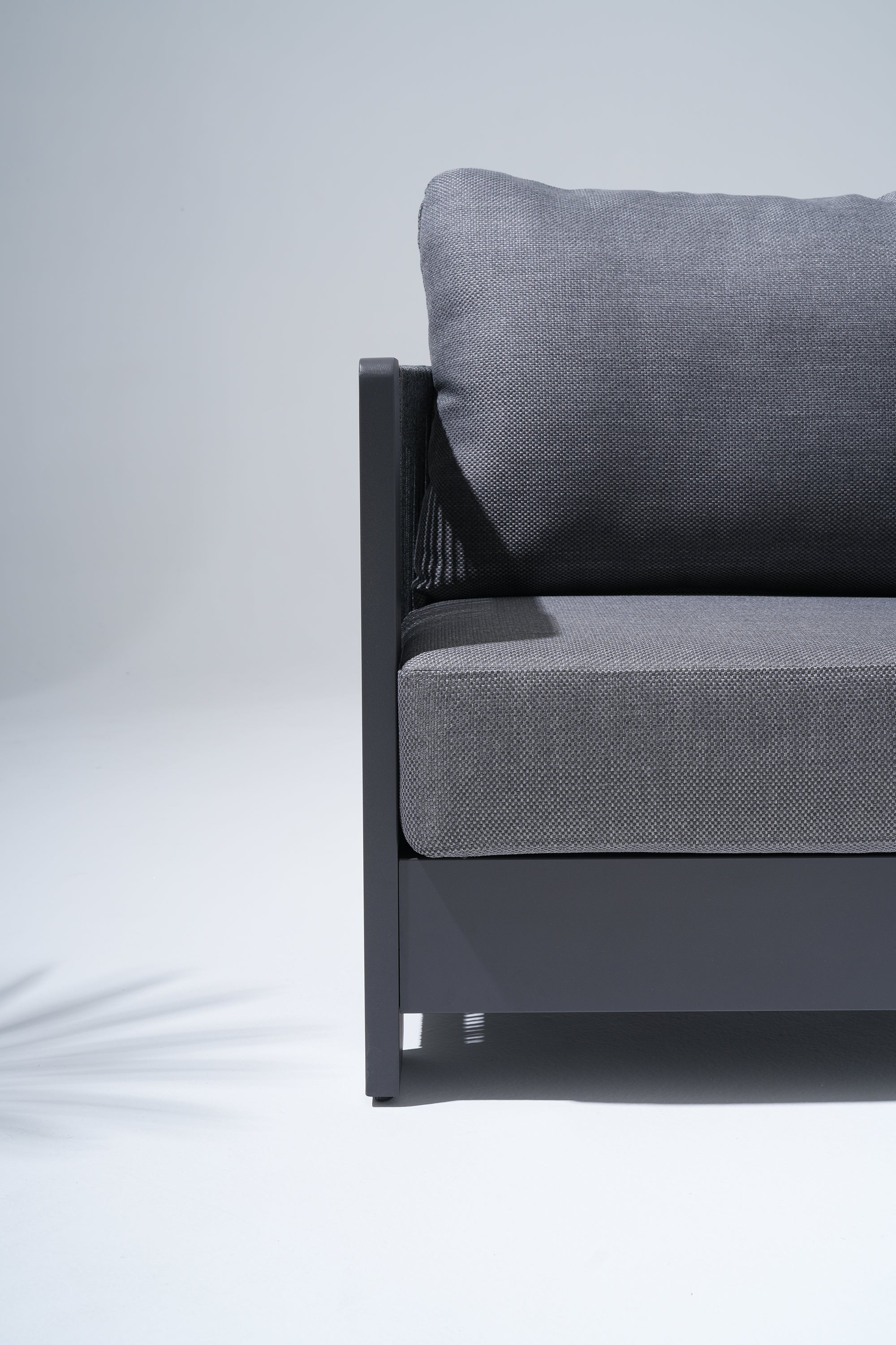 Gray outdoor single sofa with dark grey metal frame