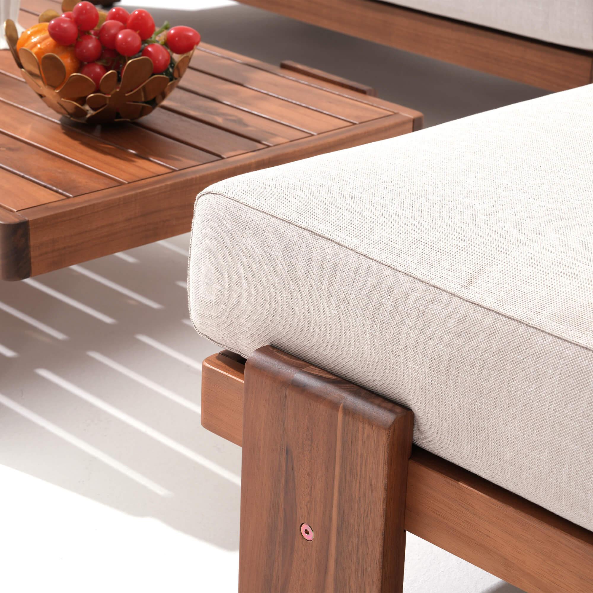 Wooden table with a bowl of fruit next to a cushioned acacia wooden couch - Jardina Modern Premium Outdoor Patio Furniture Sets