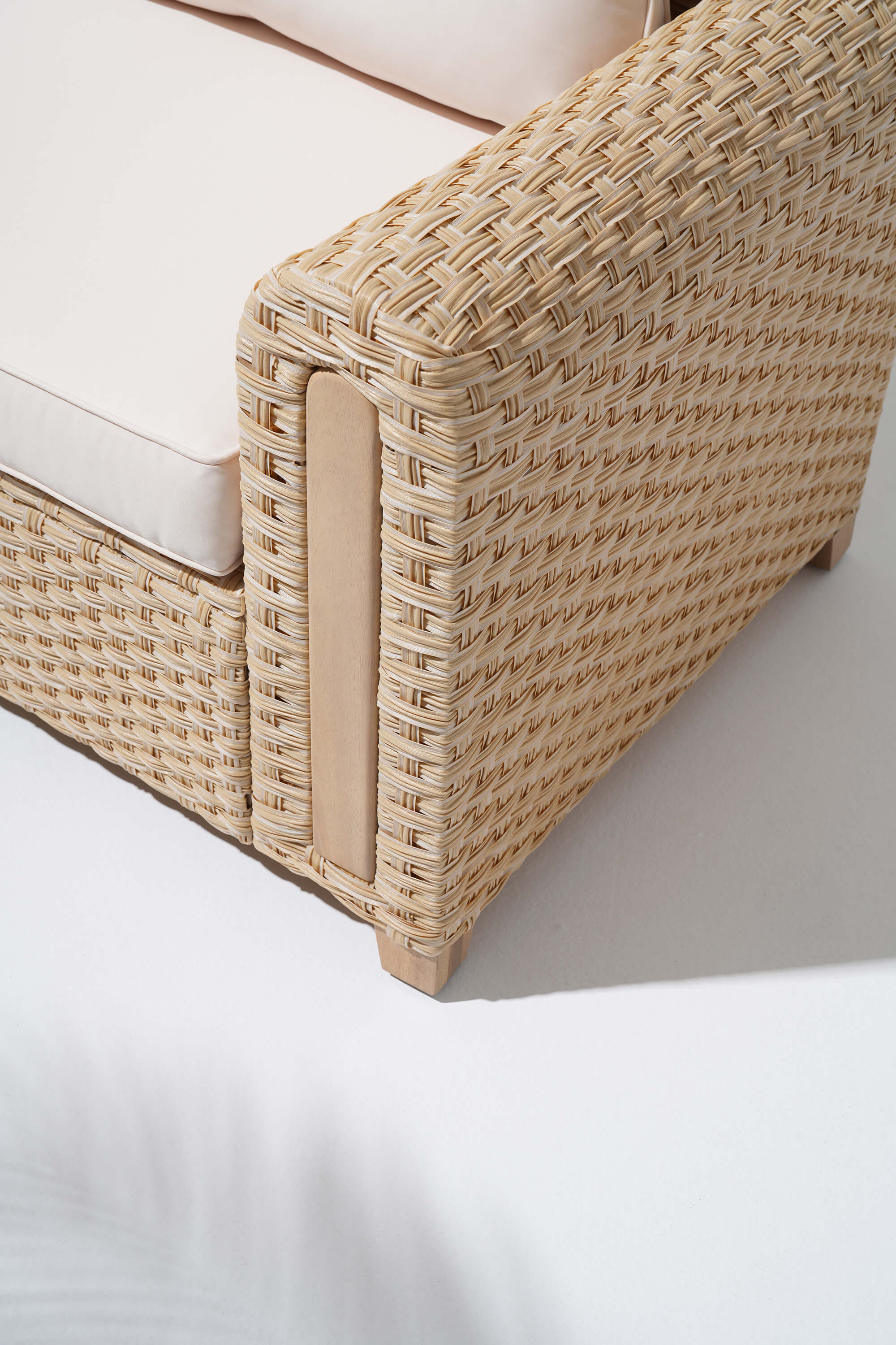 Close-up of a wicker design sofa with beige cushion