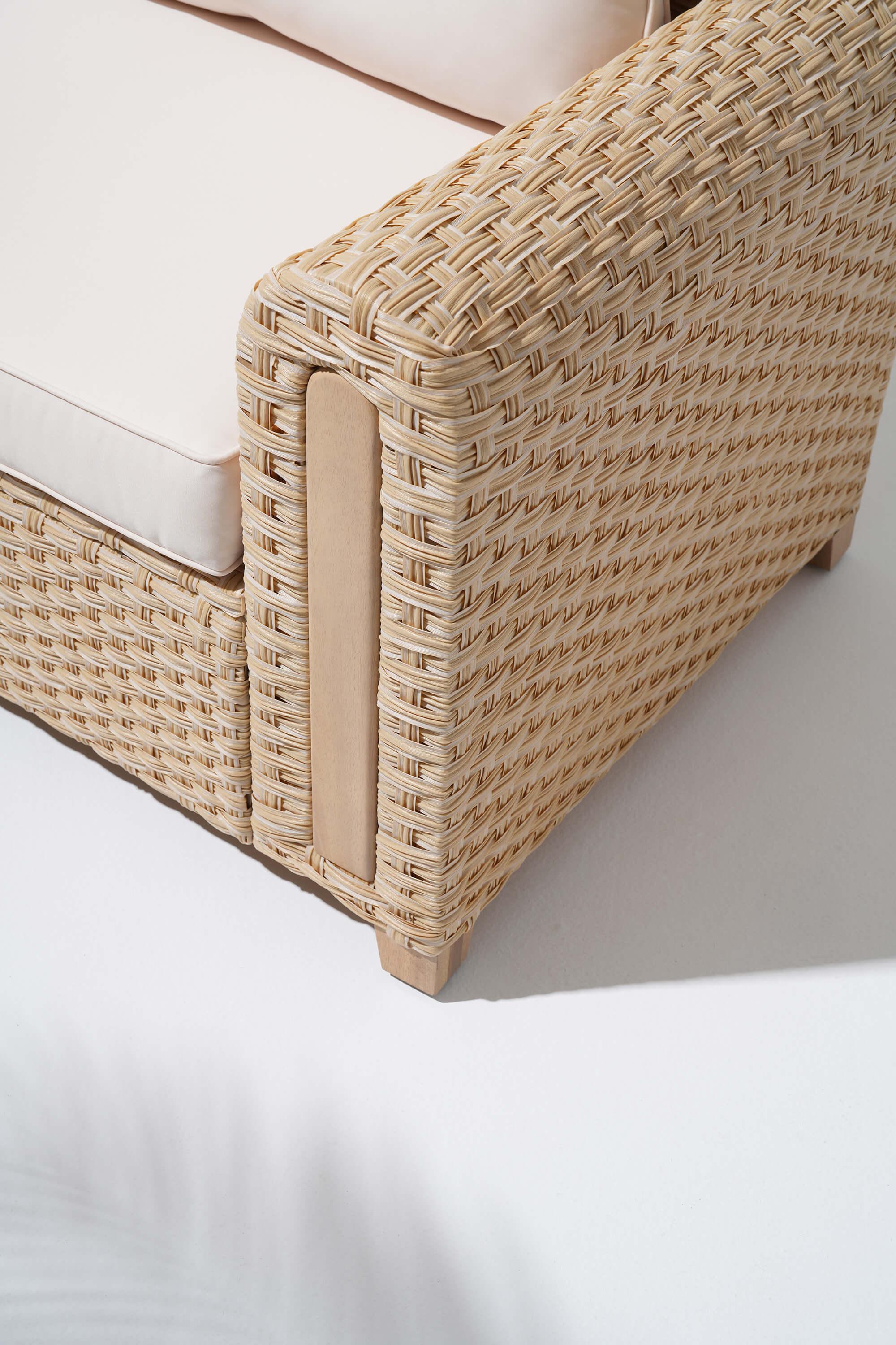 Close-up of a wicker design sofa with beige cushion