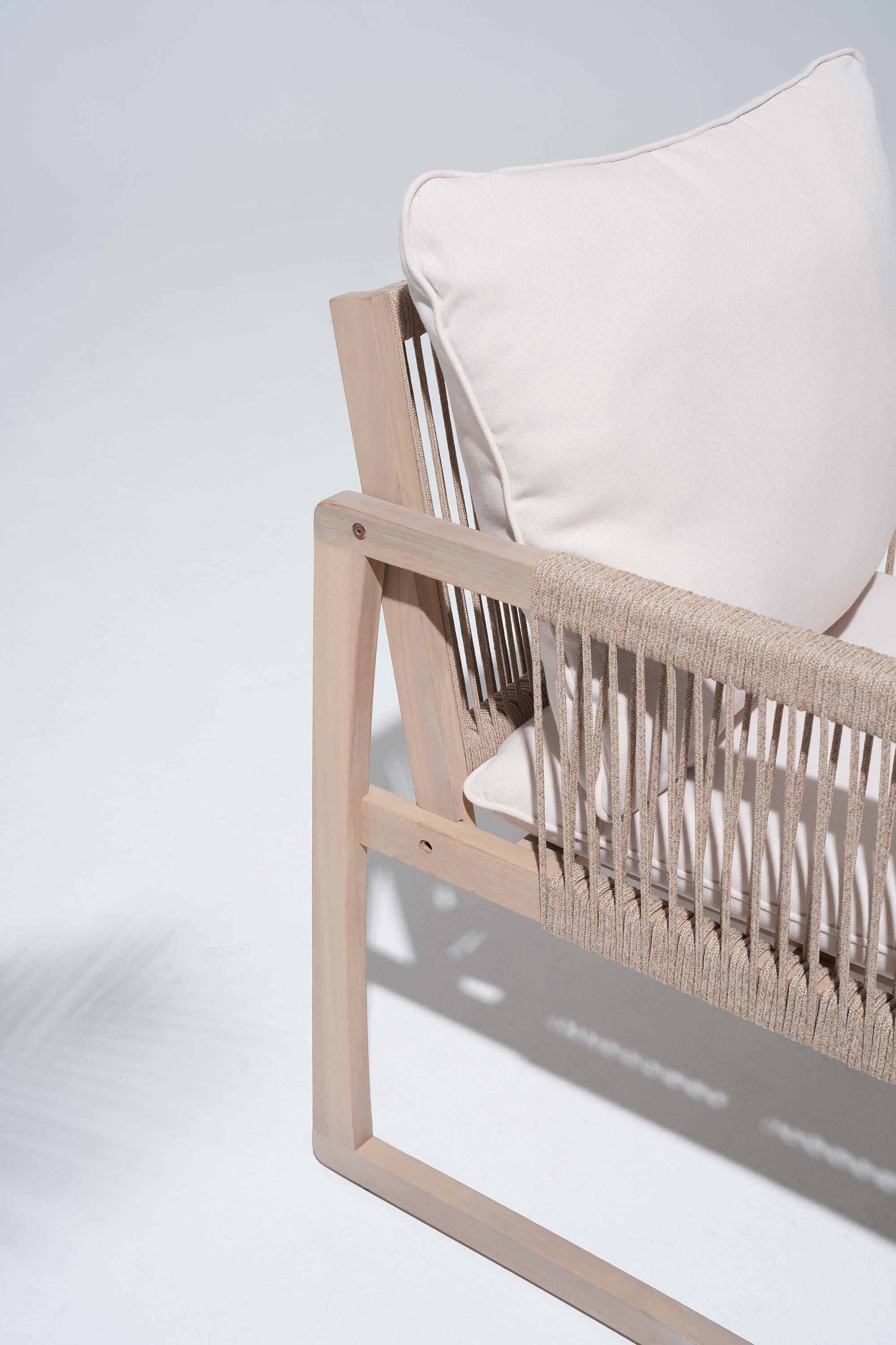 Woven chair with a white cushion