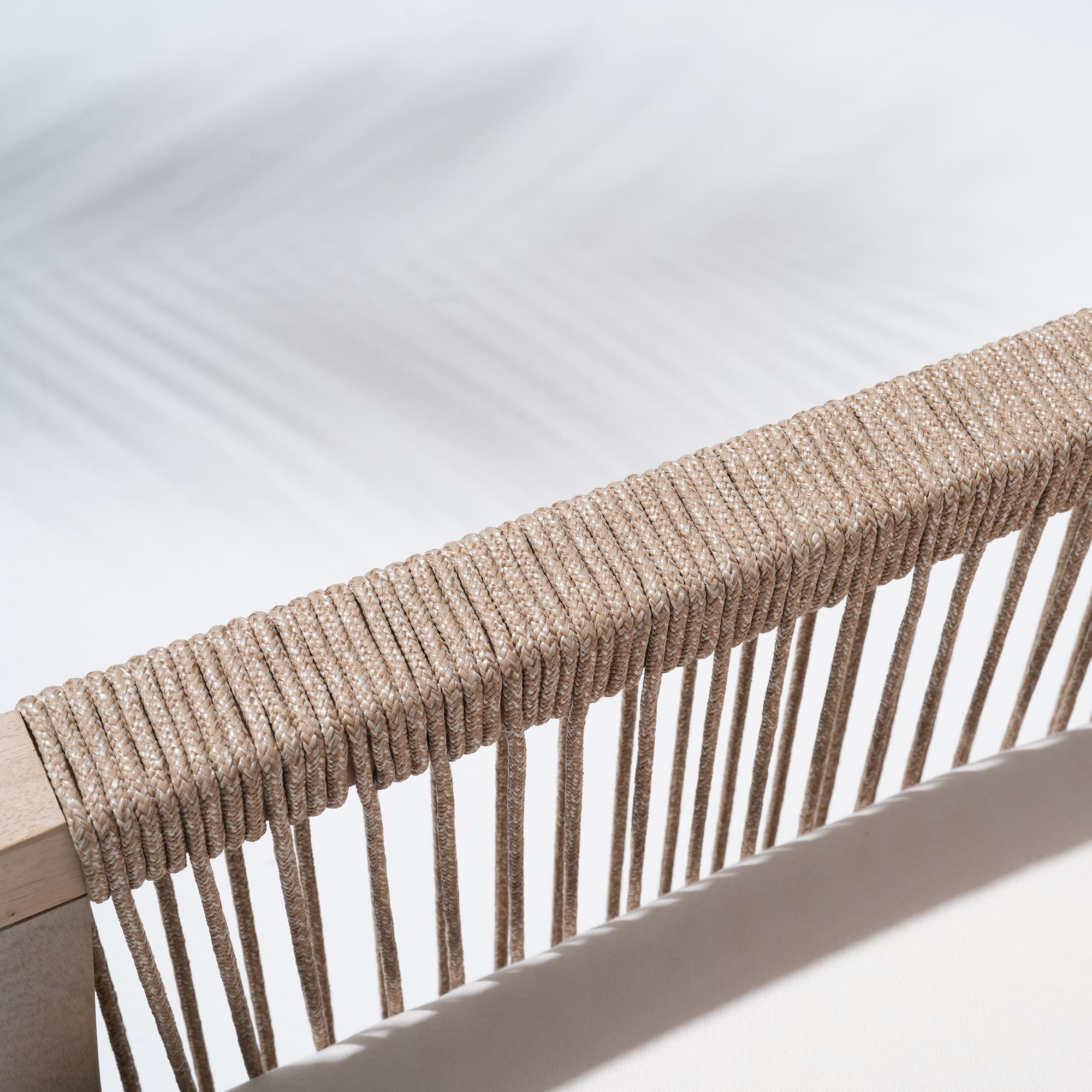 Close-up of a woven beige rope armrest