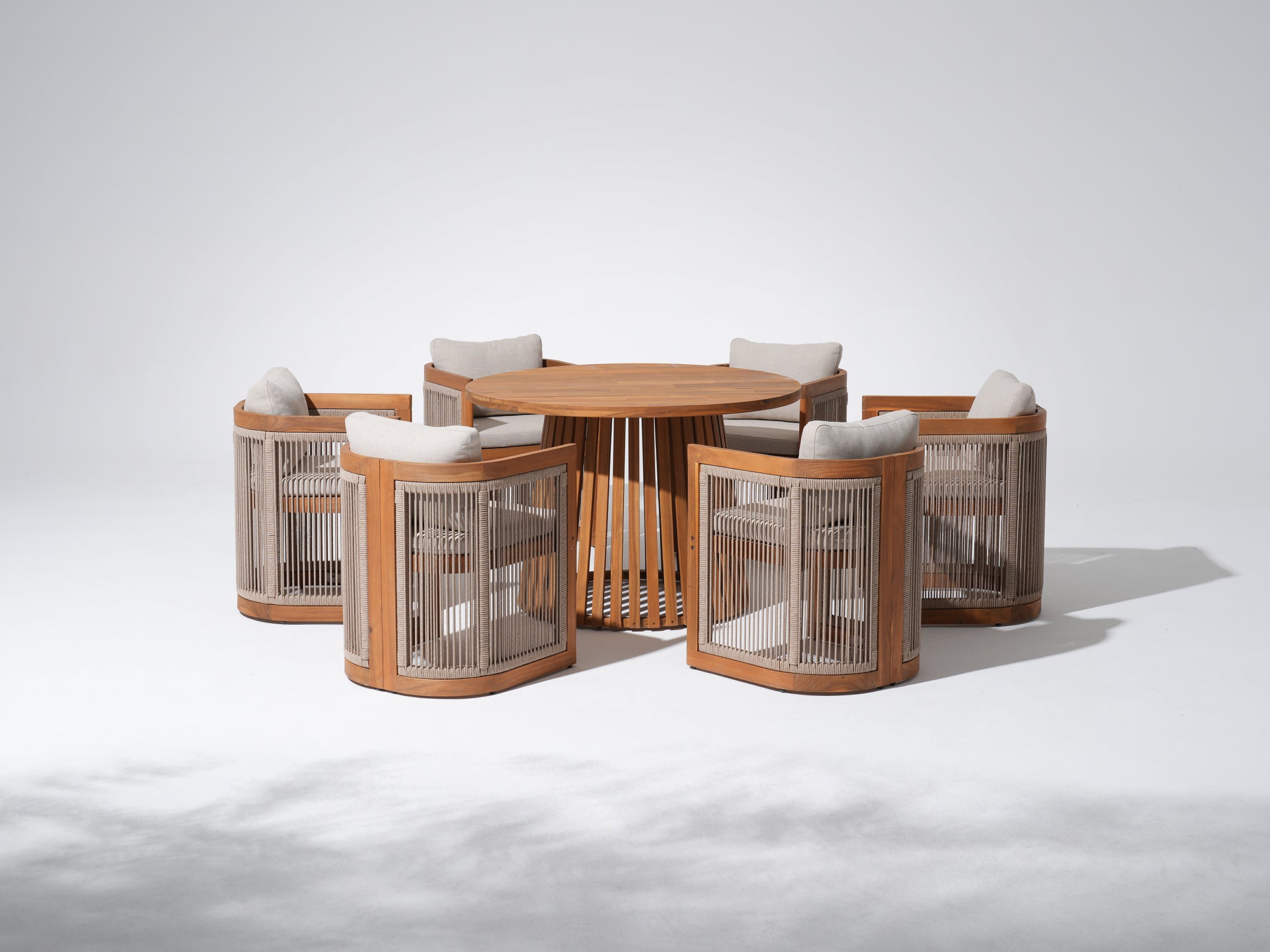 Round acacia wooden dining table with six matching chairs, rope design, gray cushions - Jardina Premium Modern Outdoor Dining Furniture
