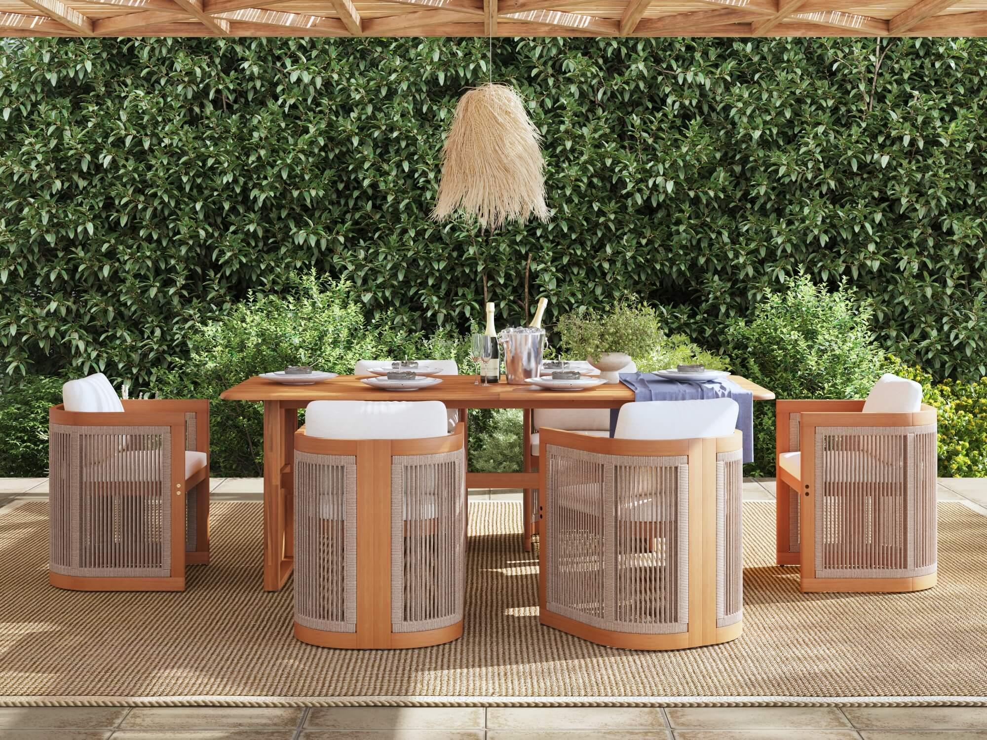 Outdoor dining setup with acacia wooden table and chairs against a green hedge- Jardina Modern Premium Patio Outdoor Furniture