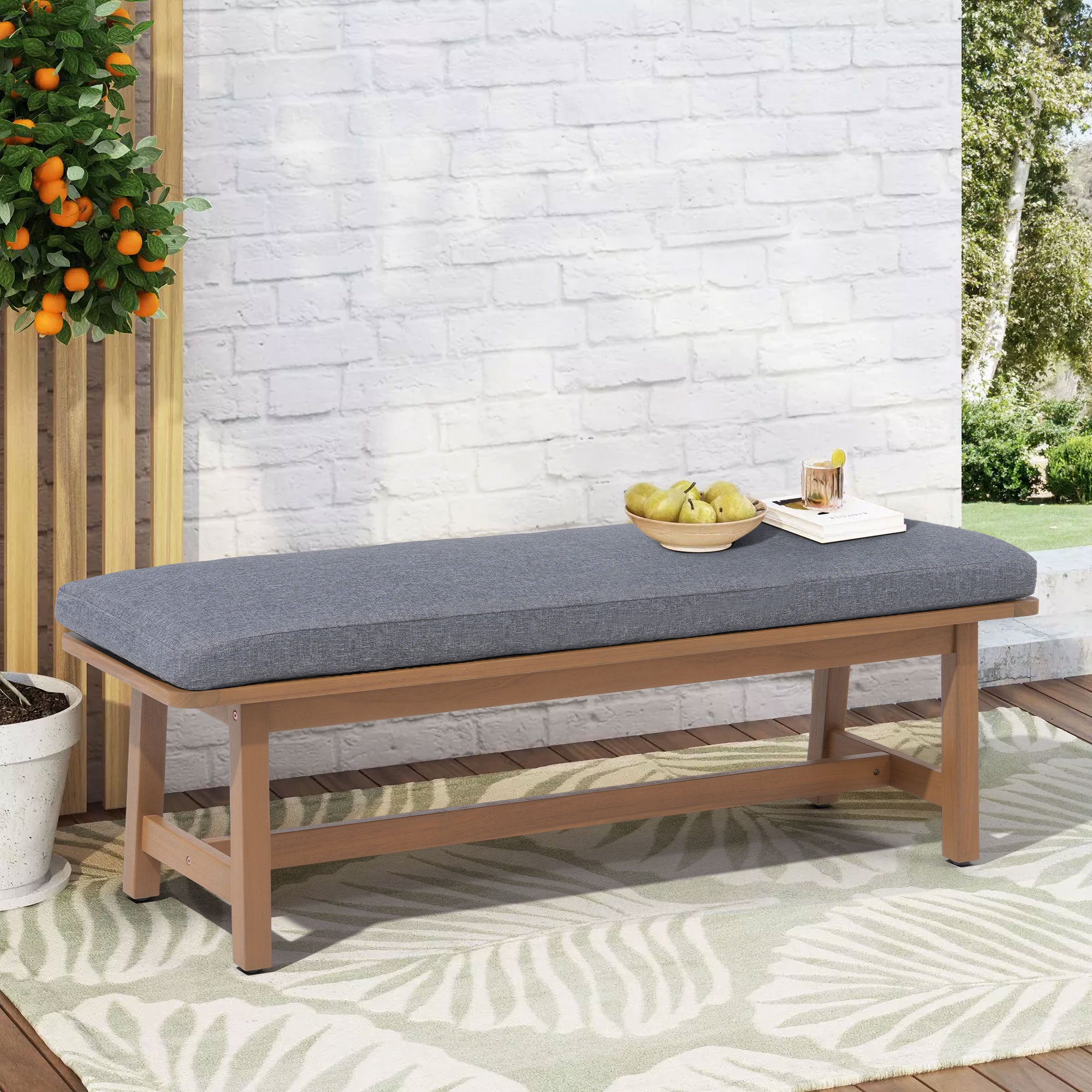 Wooden bench with a gray cushion on a patio- Jardina Modern Premium Patio Outdoor Furniture