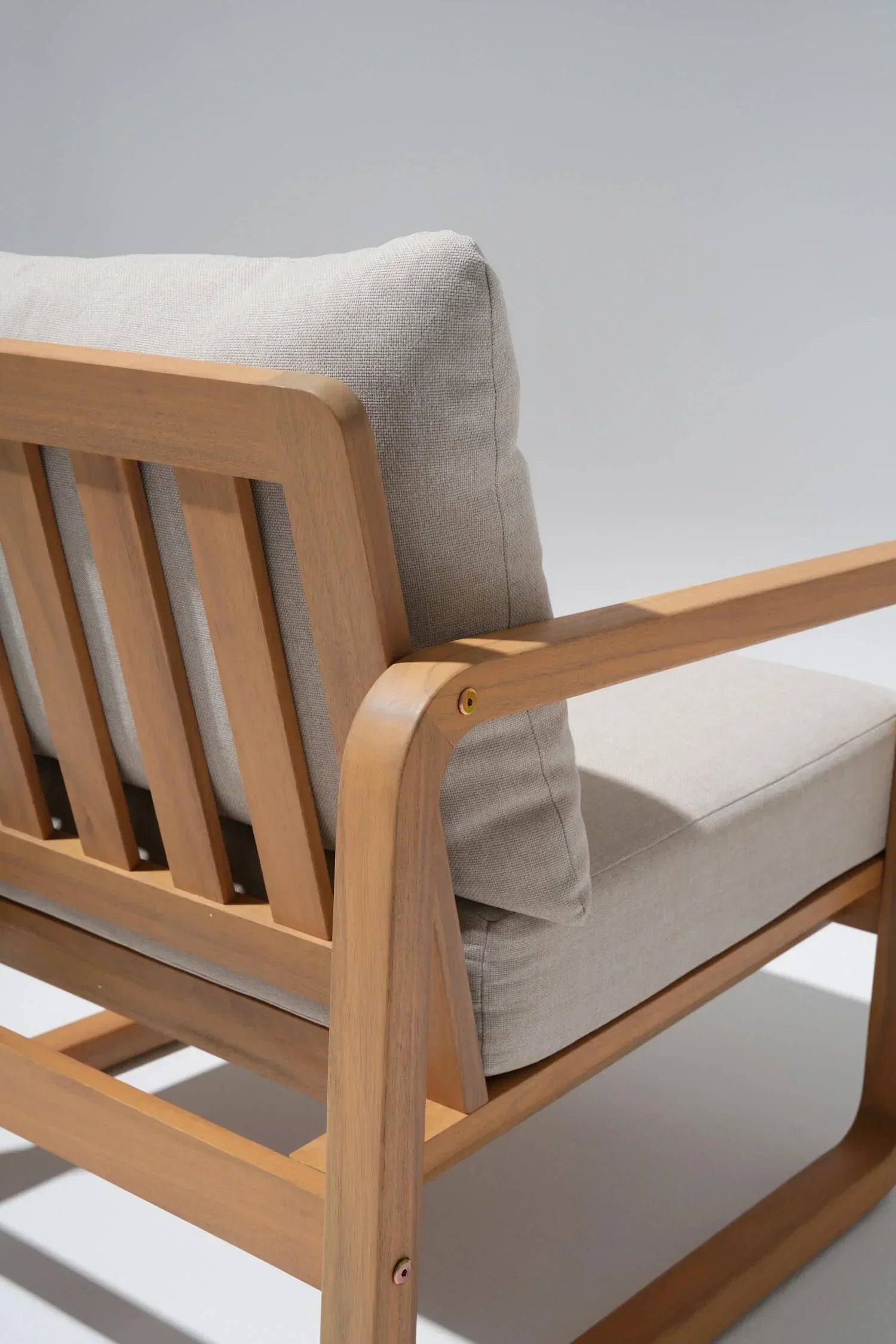 acacia Wooden chair with beige cushions, armrest detail - Jardina Modern Premium Outdoor Patio Furniture