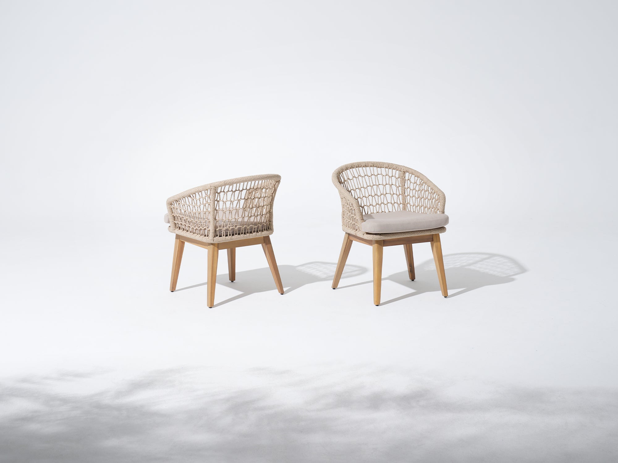 Two rope chairs with wooden frames