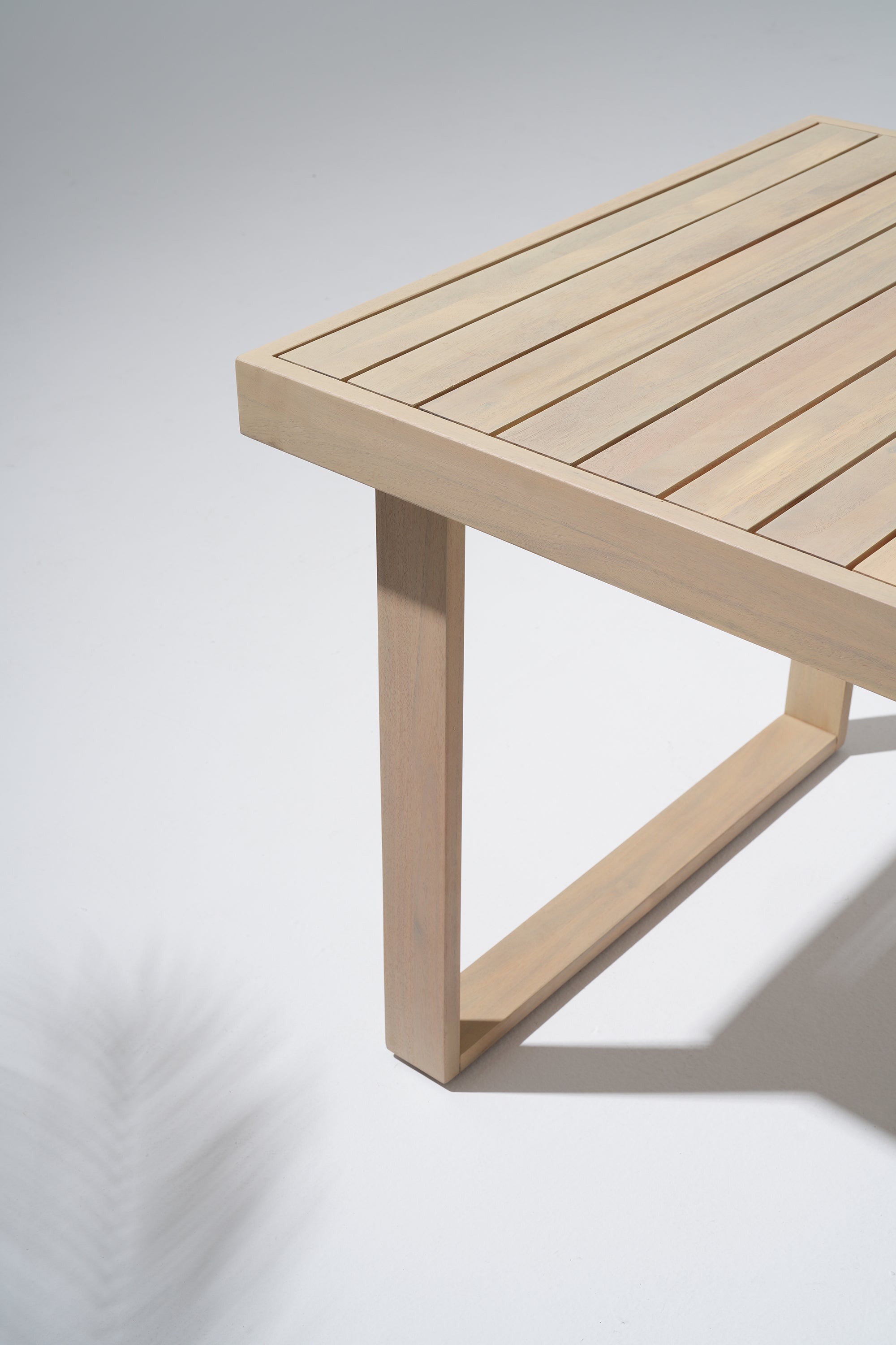 the leg and tabletop of a acacia wooden table detail