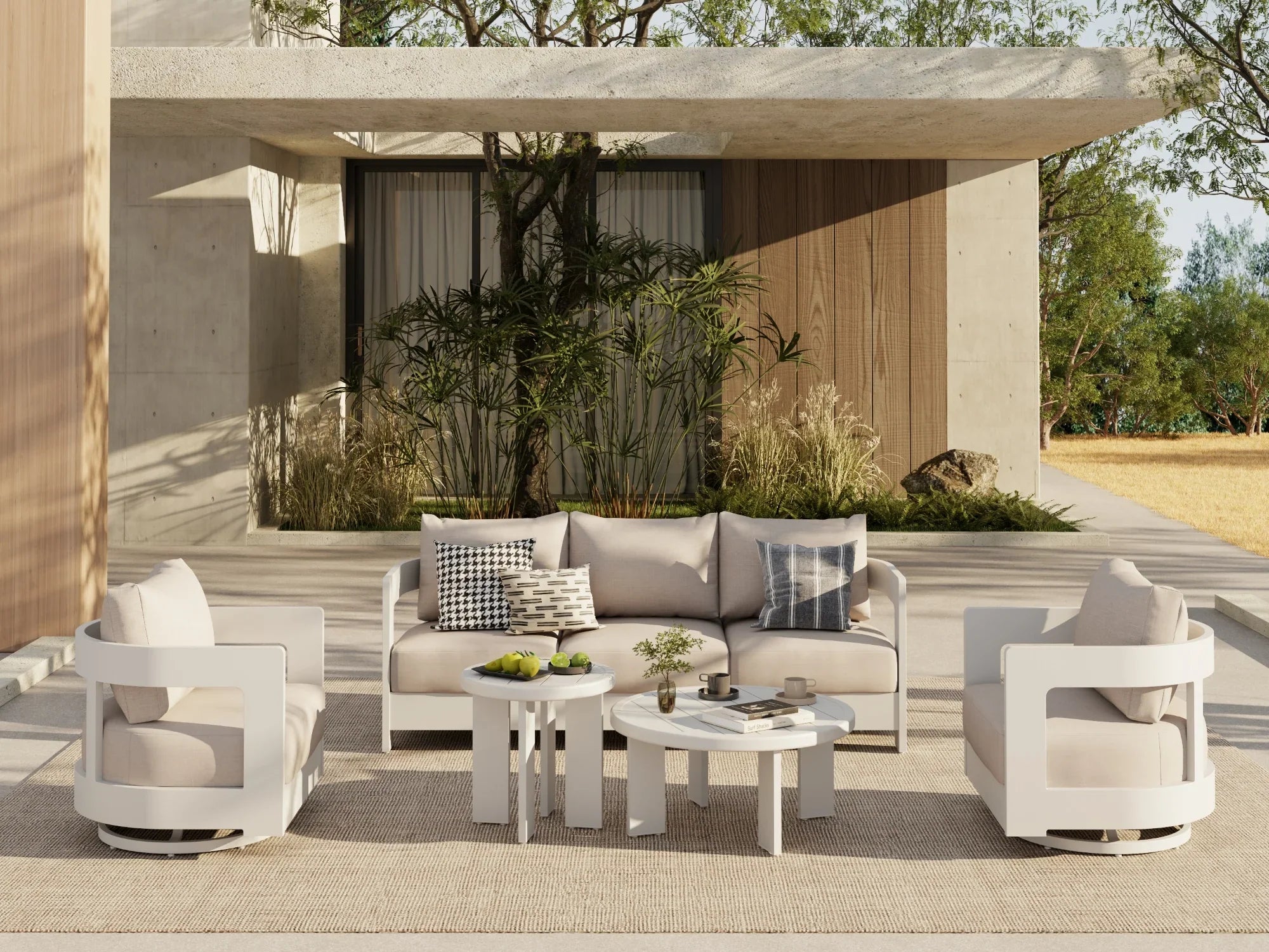Modern outdoor furniture conversation set with beige and white chairs and sofa in a stylish patio setting