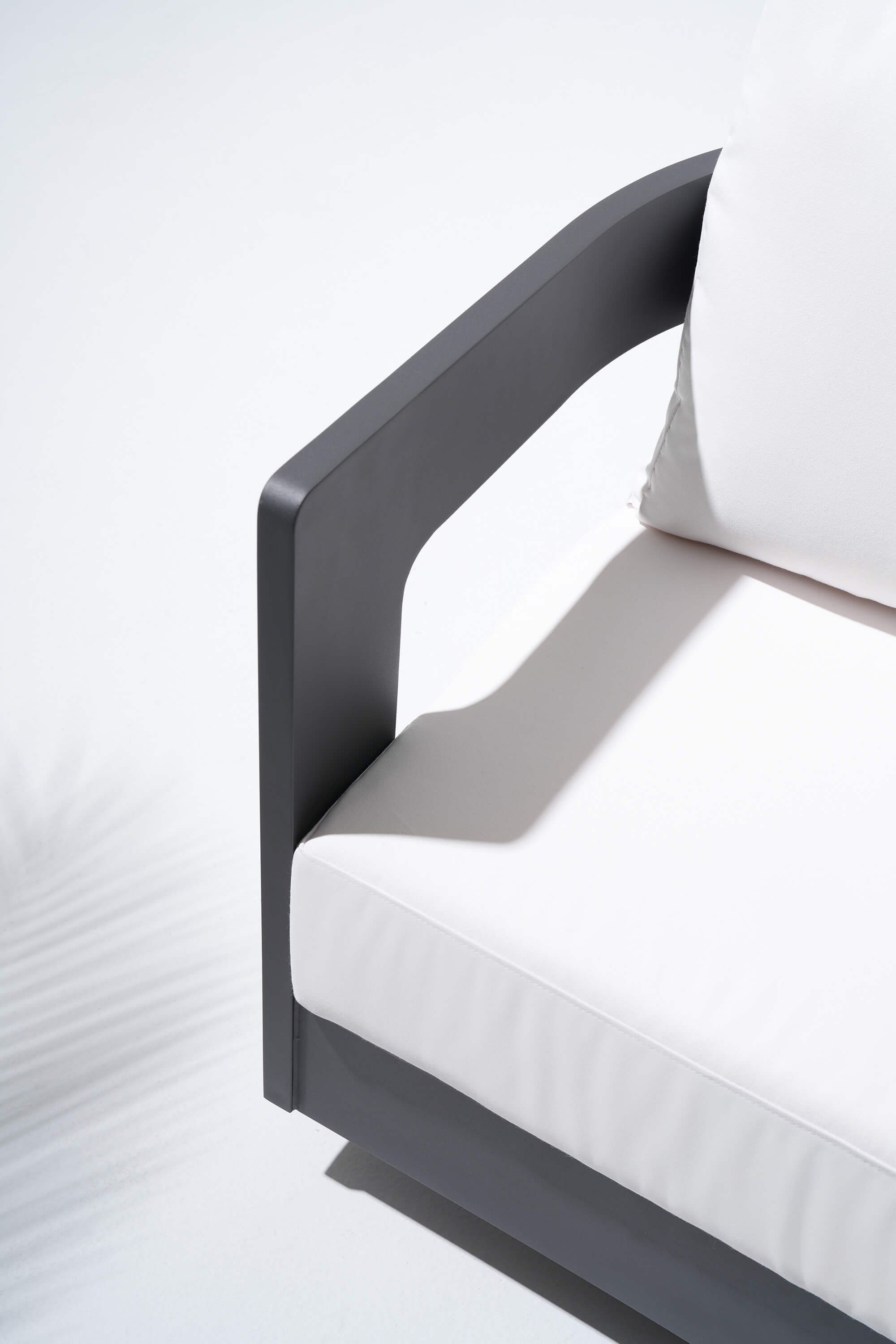 black outdoor chair with white cushions