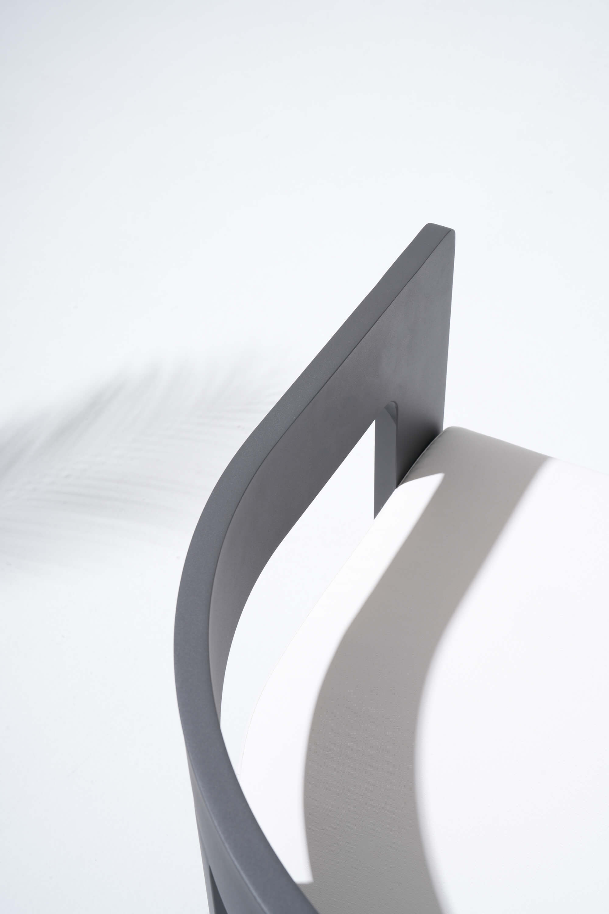 Modern metal chair with a curved design armrest