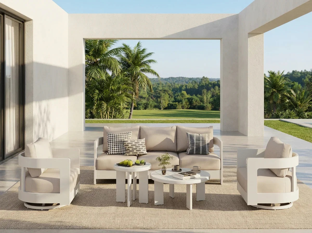 Modern outdoor furniture conversation set with a view of palm trees and greenery