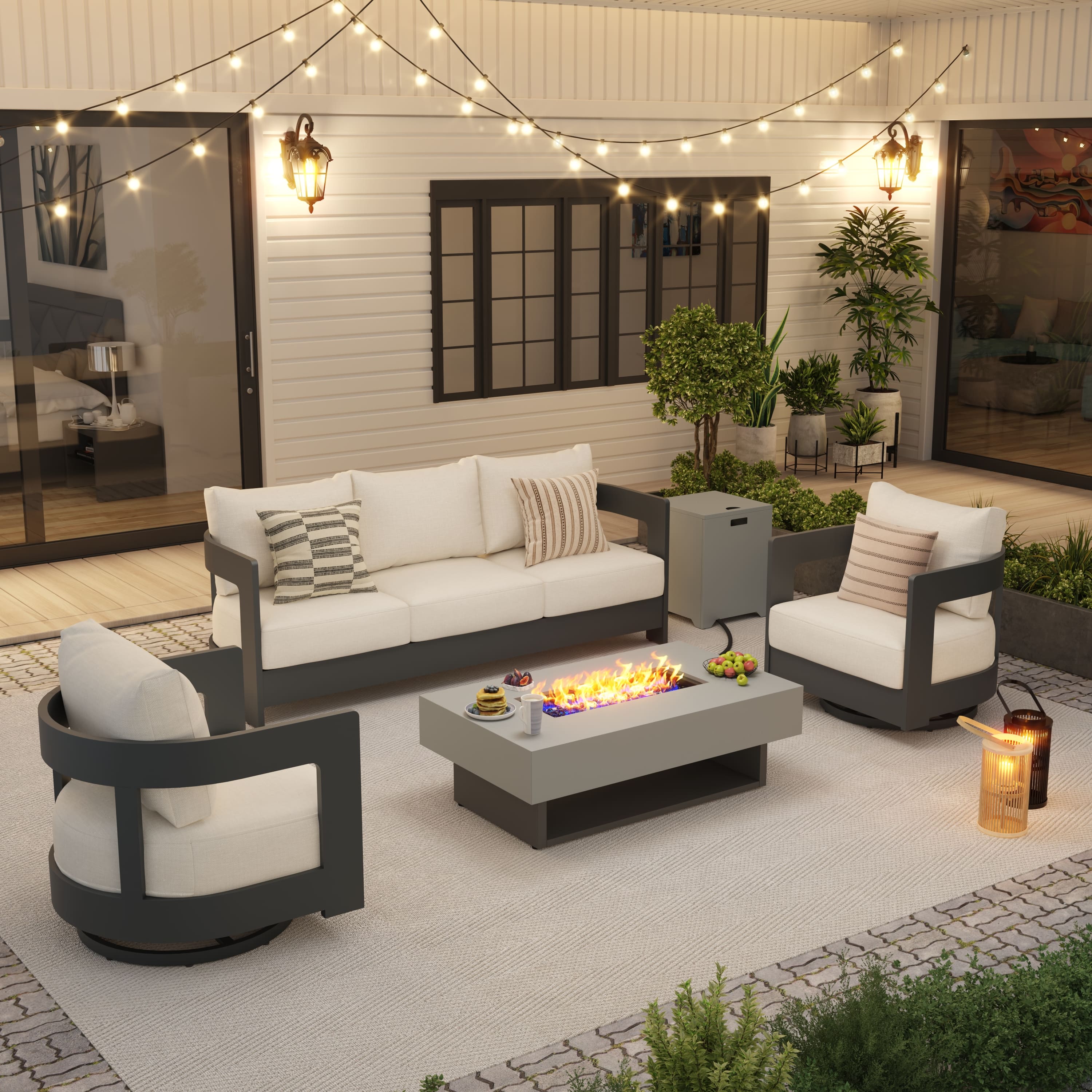 Outdoor patio set with fire pit table, chairs, and sofa under string lights. #color_grey